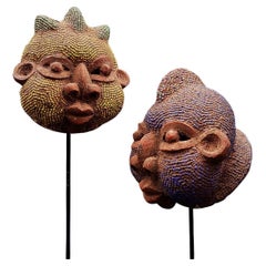 Pair of African terracotta and pearl heads