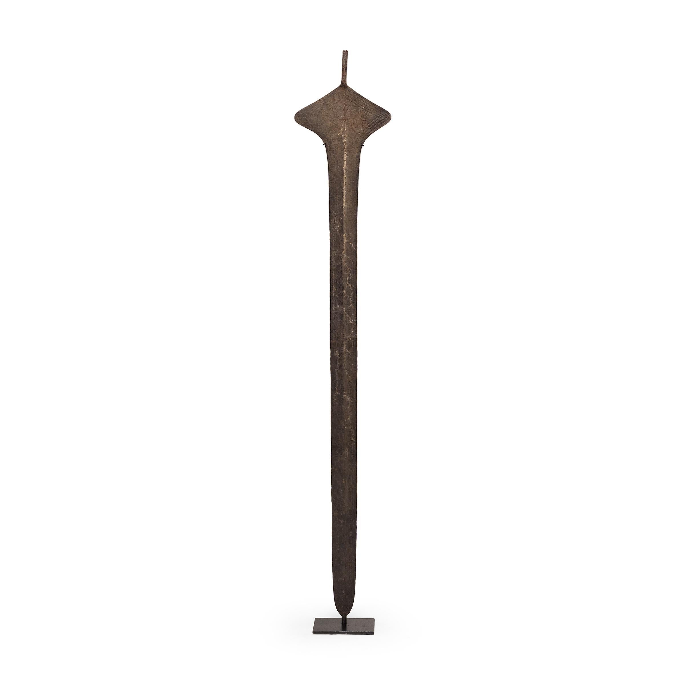 While shield and spear were central to African combat, these iron sword blades were most likely made to serve as pieces of trade currency. Many pre-colonization African currencies were modeled after objects of inherent value, resulting in sculptural