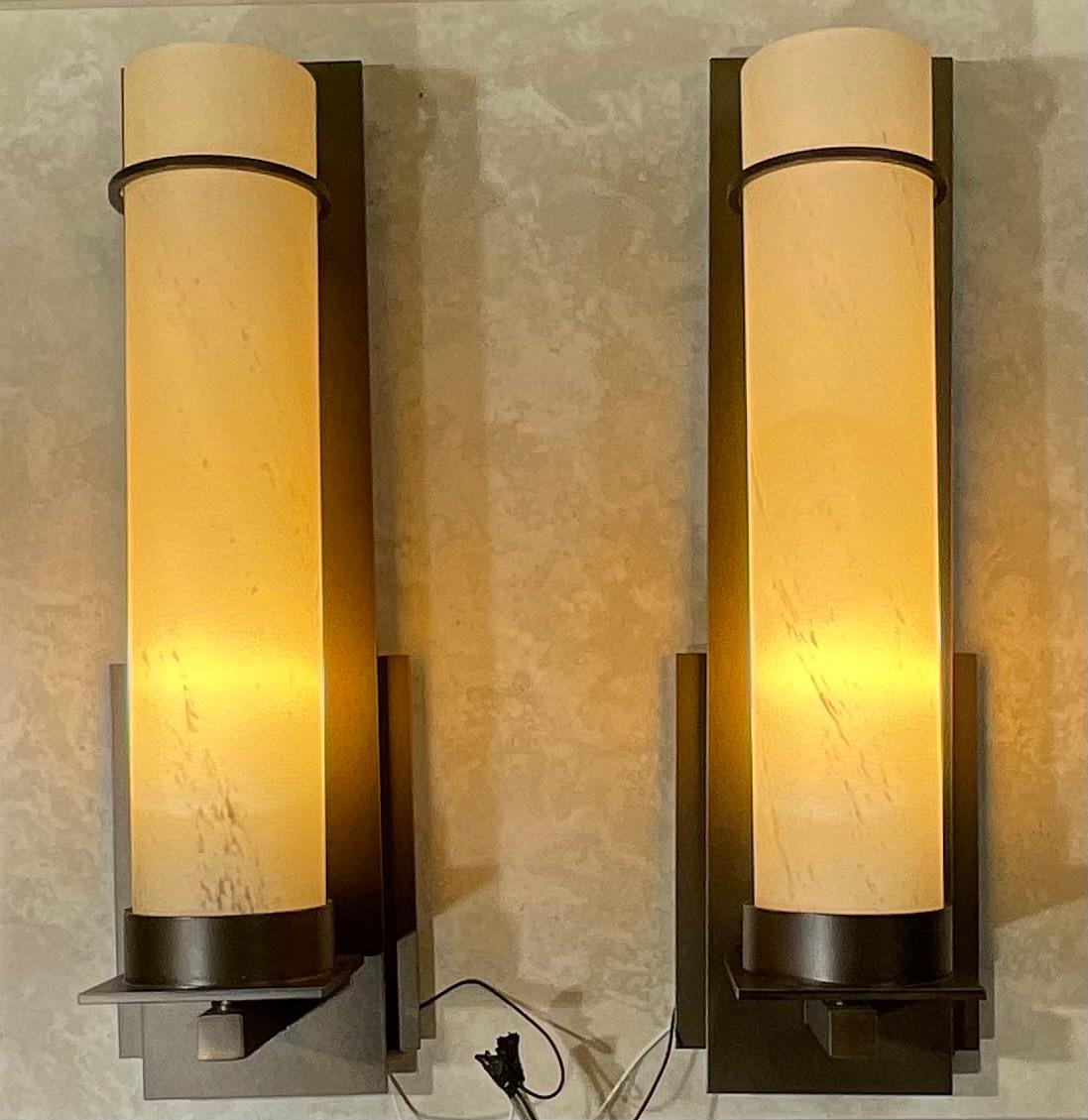 Beautiful pair of after hours sconces made of sculpted metal dark smoke finish , with long narrow art glass marblize look tube . One 60/watt light each, providing visual interest .
Made in the USA

ULCUL listed 