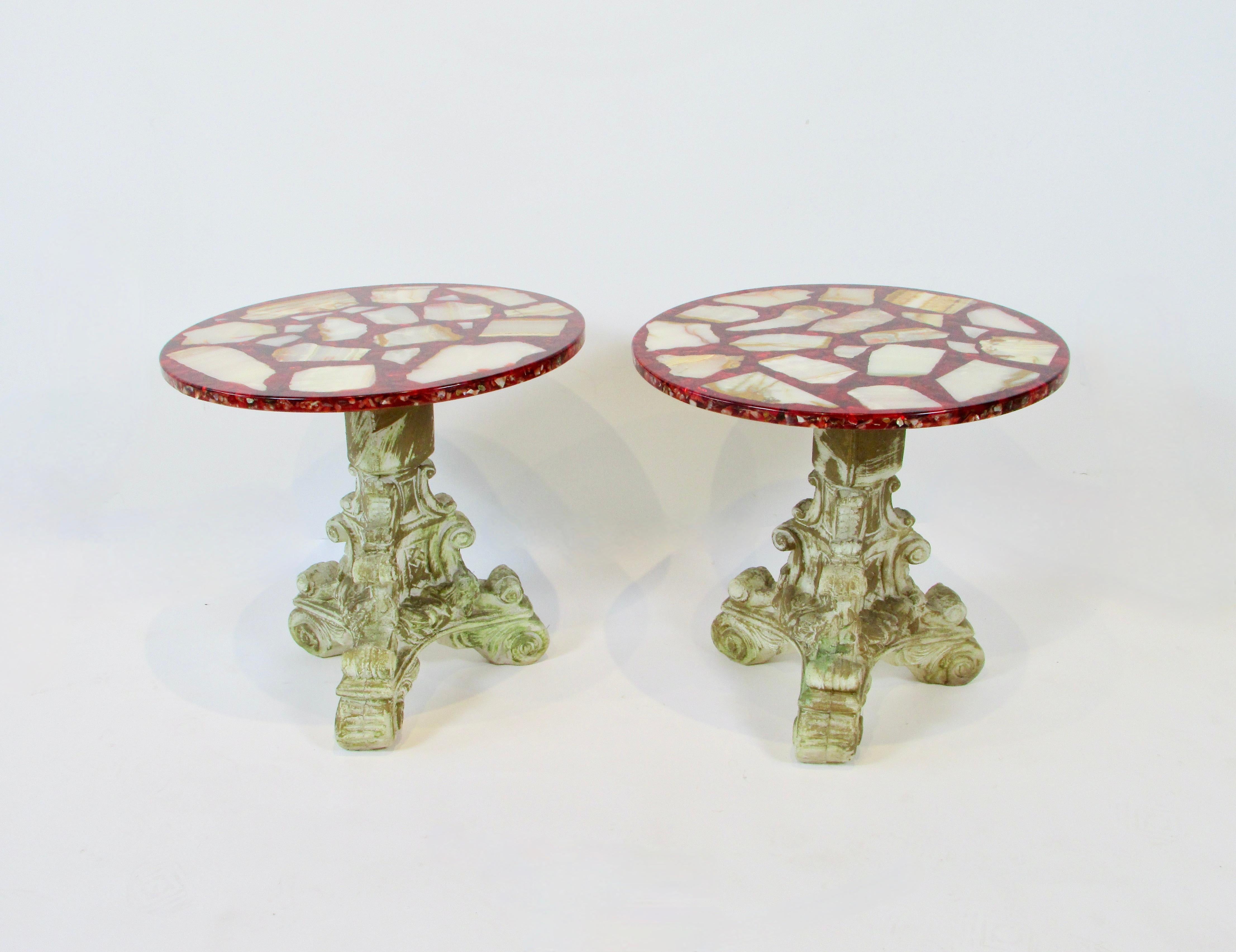 Pair of tables in the romantically stylized Hollywood Regency look . 
 Brushed gold leaf Neoclassic acrylic composition base accentuates the vivid ruby red table tops .