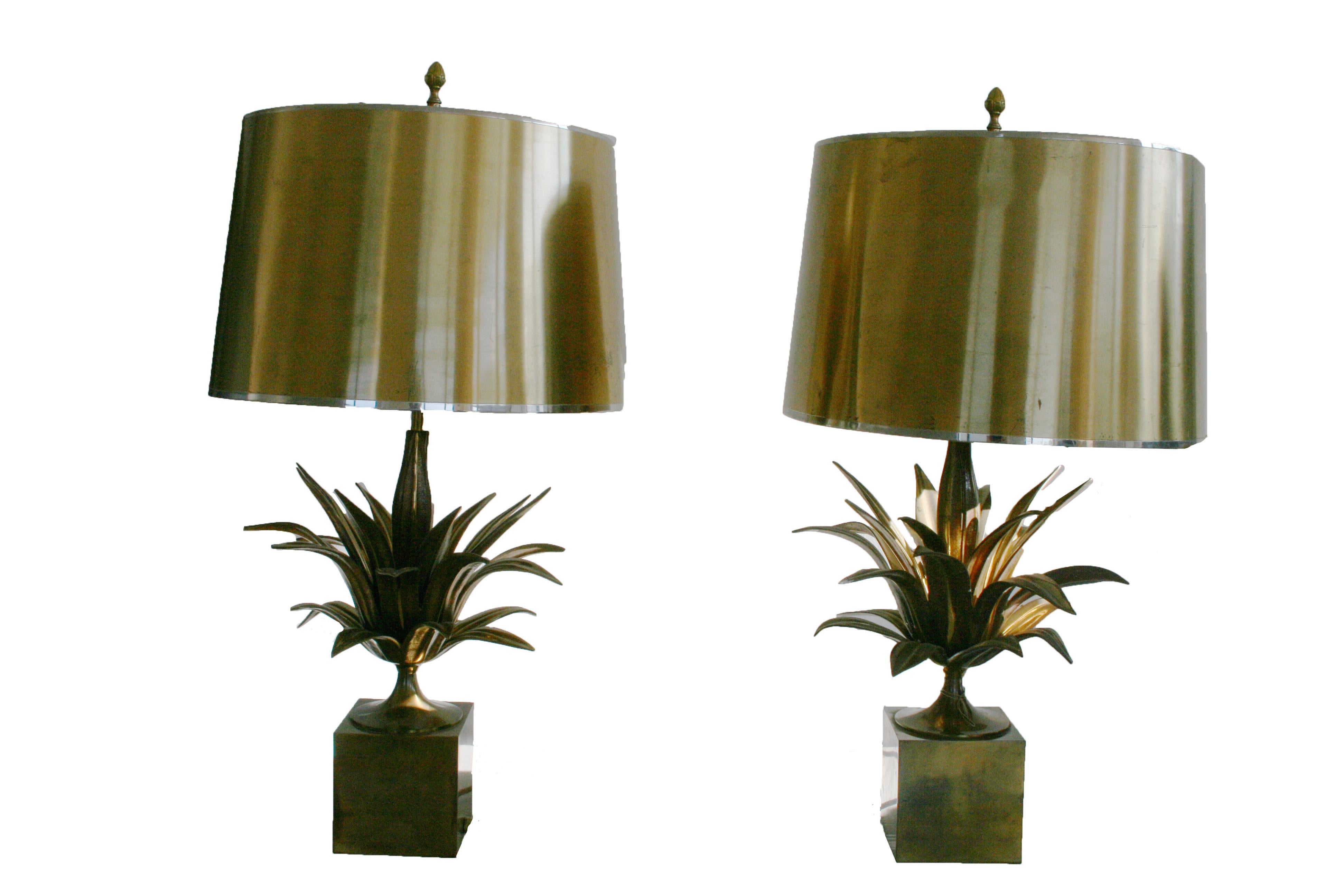 These beautiful pair of table lamp are unique pieces made in brass. The dedicate and detailed metal work shows the Agave Leaves and are placed on a metal pedestal. They also have their original metal lamp shades.
 