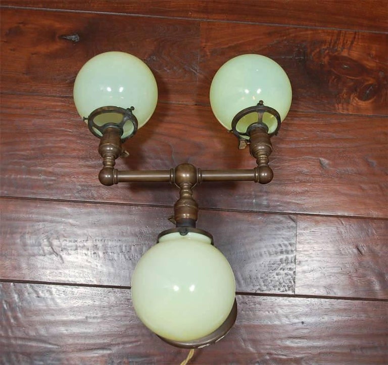 Revival Pair of Aged Brass Sconces with Vaseline Glass Globes 'Triple' For Sale