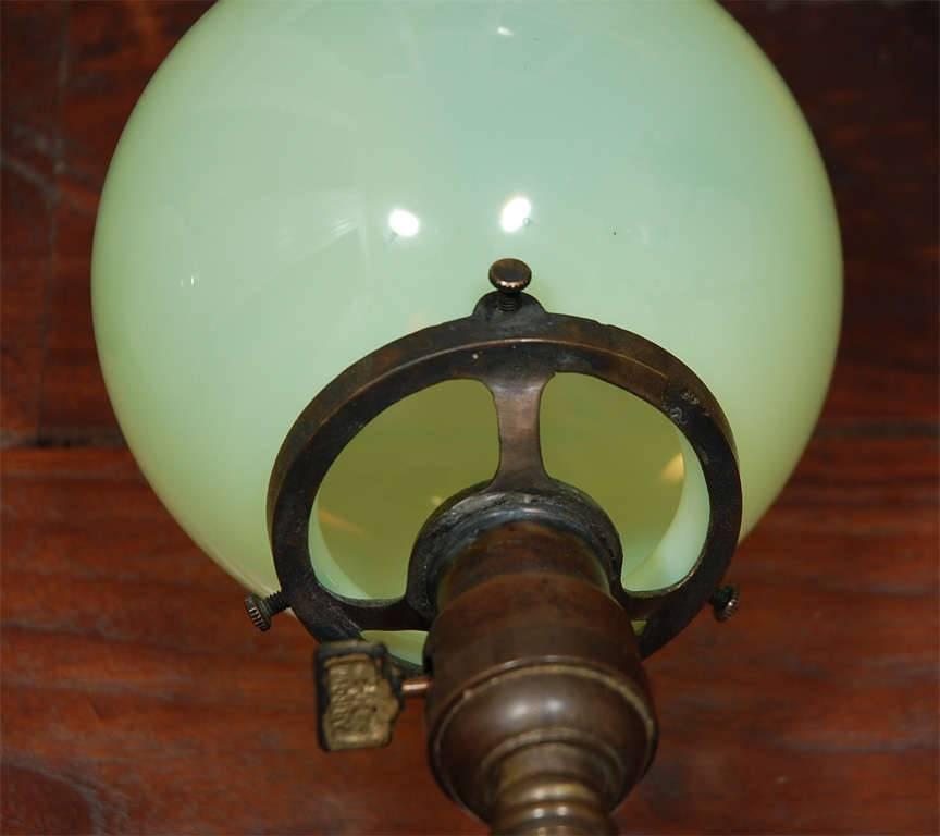 American Pair of Aged Brass Sconces with Vaseline Glass Globes 'Triple' For Sale