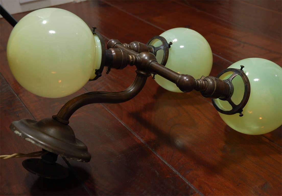Pair of Aged Brass Sconces with Vaseline Glass Globes 'Triple' For Sale 1