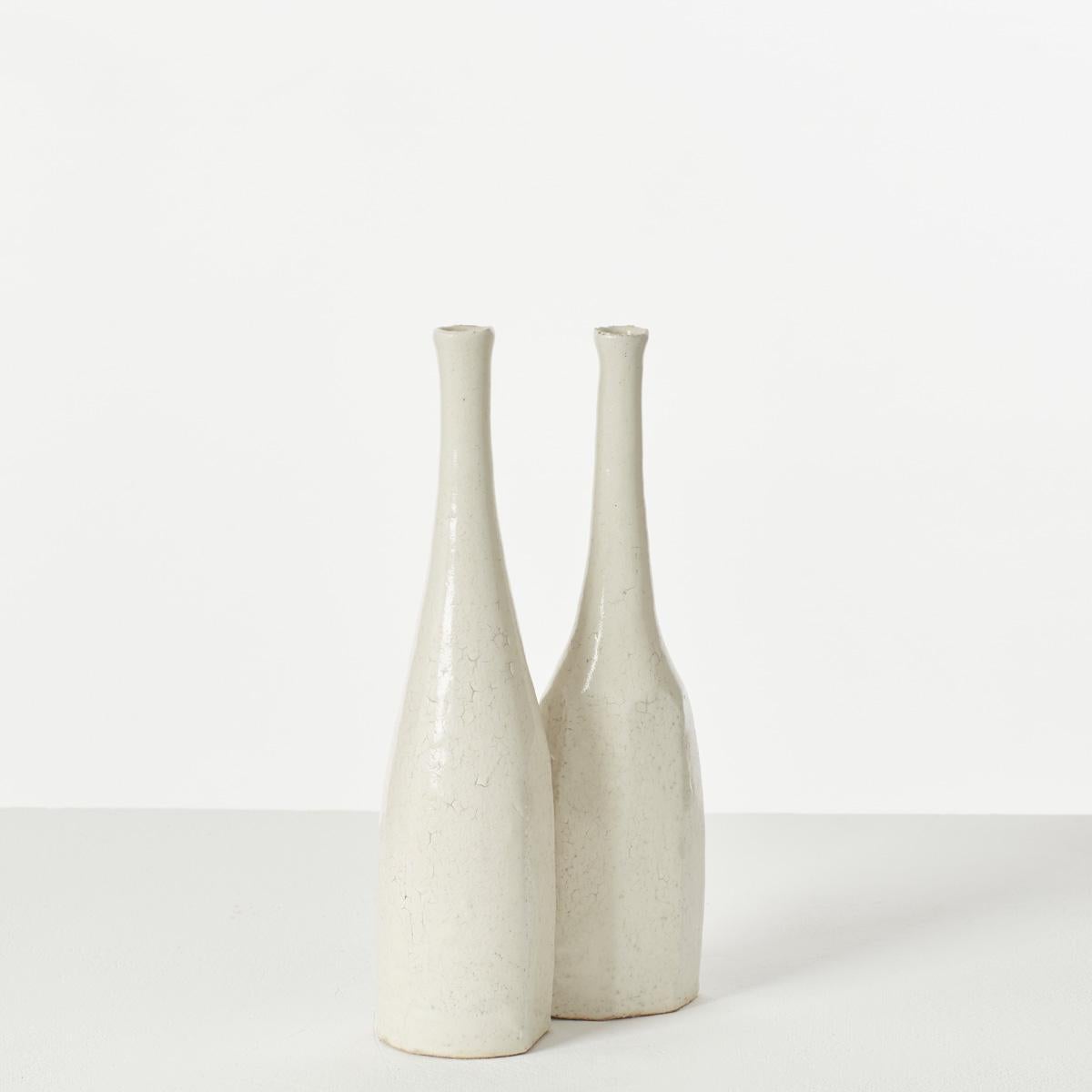 A pair of beautifully formed bottle vases, by Japanese ceramicist Akiko Hirai (1970-). Hirai produces domestic ceramicware for everyday use. Basing her designs on the Japanese aesthetic of relativity, she embraces the beauty of irregularity,