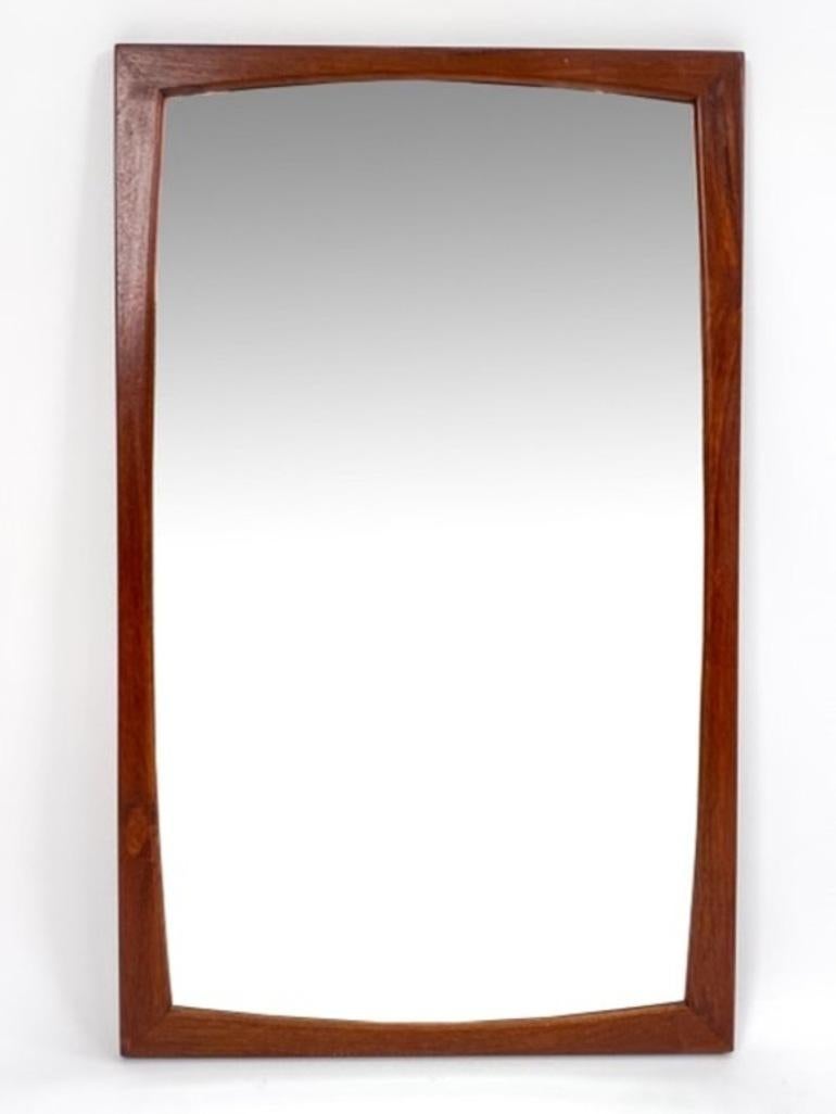 A stylish pair of Danish mid-century wall mirrors with teak frames. Designed by Aksel Kjersgaard for Odder, with heat stamp to back. c. 1960's.