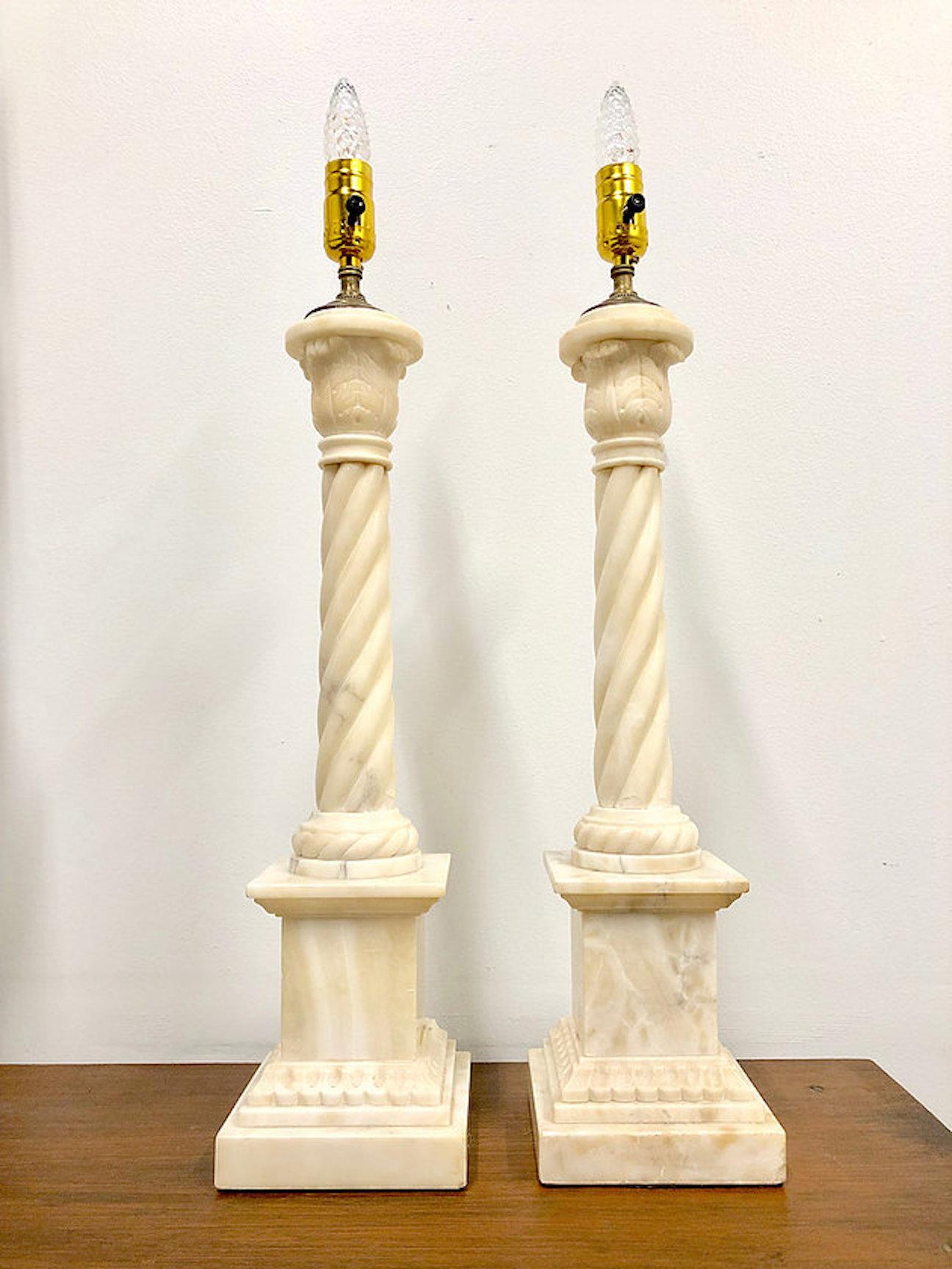 Pair of Alabaster column lamps. Lamps are in good vintage condition with visible chipping around column and base. There are no lamp shades for this listing.

Dimensions:
5 diameter x 24.5 (to socket).