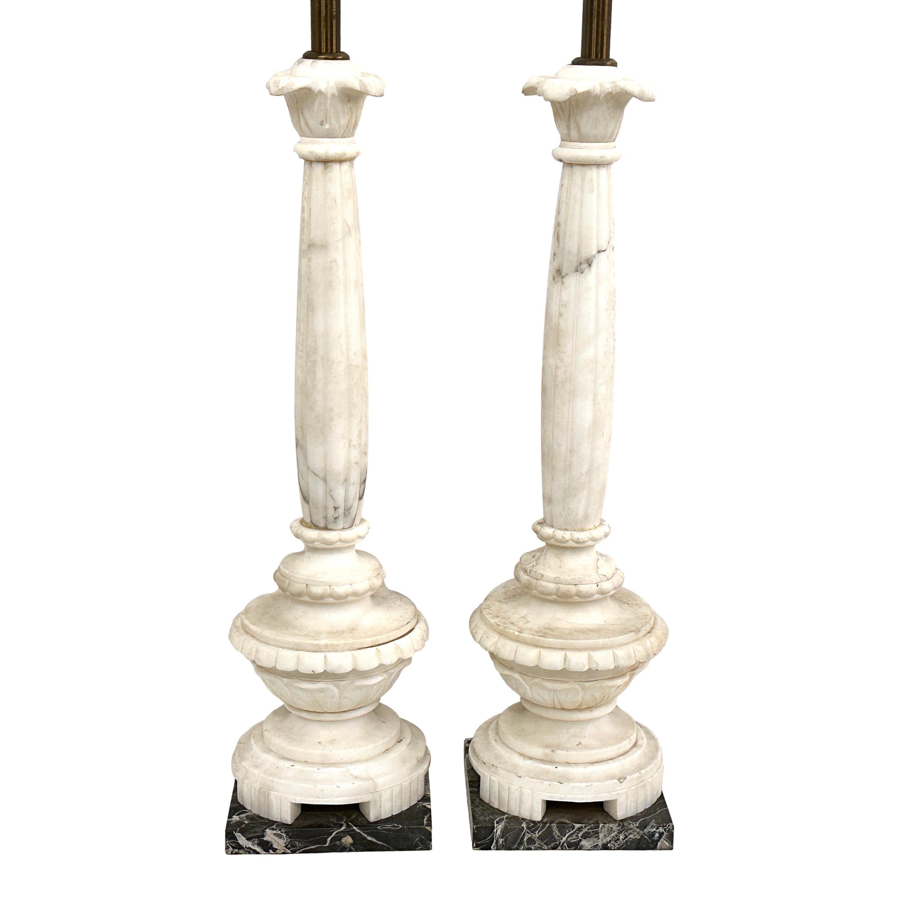 Pair of circa 1930's Italian column-shaped alabaster lamps with black marble bases.

Measurements:
Height of body: 22