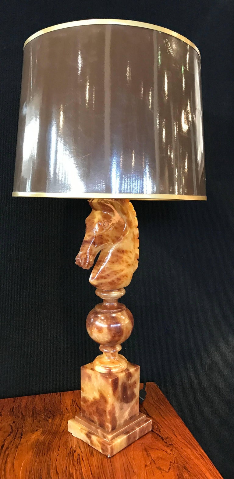 Stunning pair of Alabaster table lamps in the form of a horses head which represents the night piece of chess. Made in Italy for the famous department store Nordiska Kompaniet Stockholm Sweden in the 1940s. The lights retail their original shades.