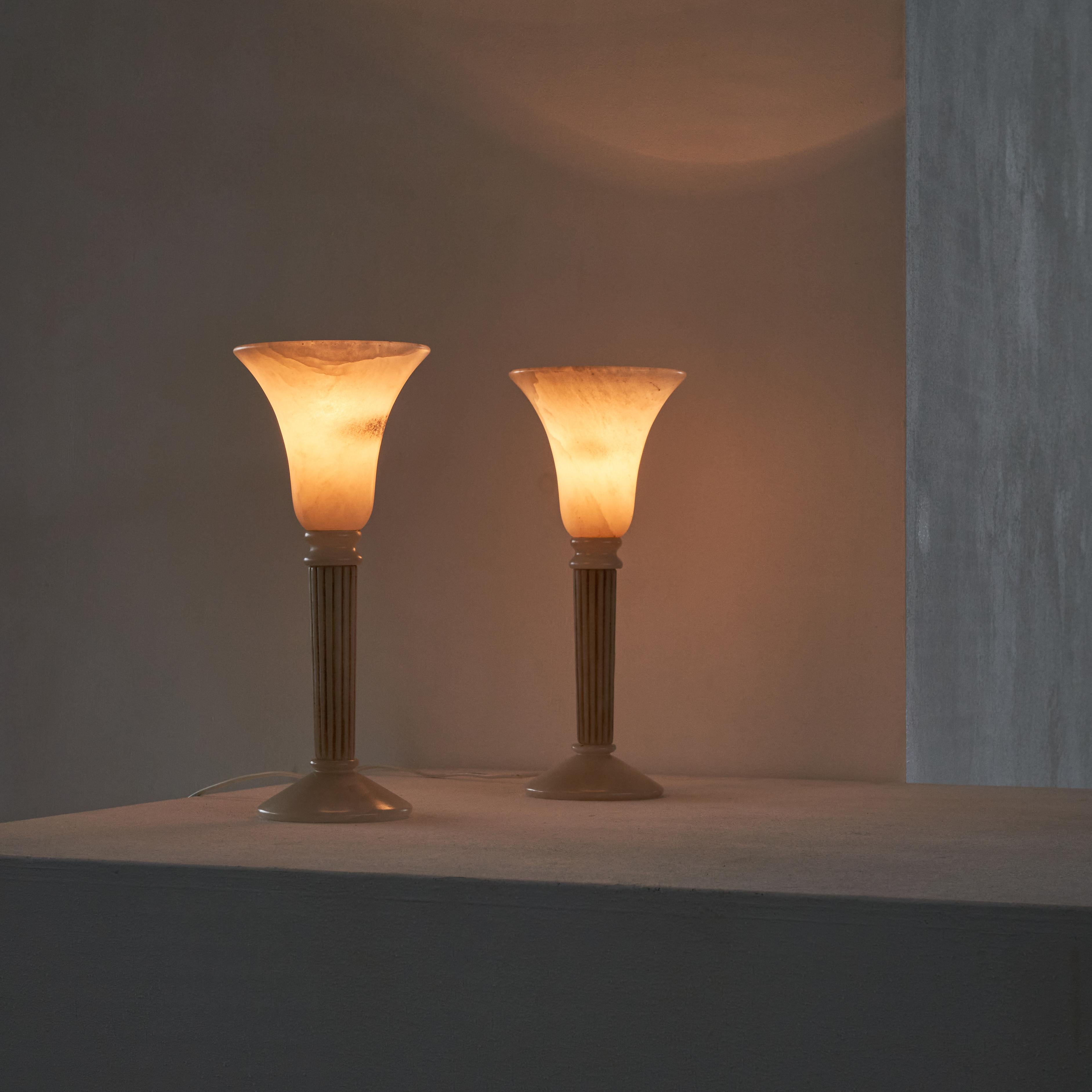Pair of Alabaster table lamps.

Wonderful pair of alabaster table lamps. Classic shape and elegance, combined with a very soft and warm light when lit. A stylish pair to lighten up your living room, bedroom or home office. 

The alabaster lights
