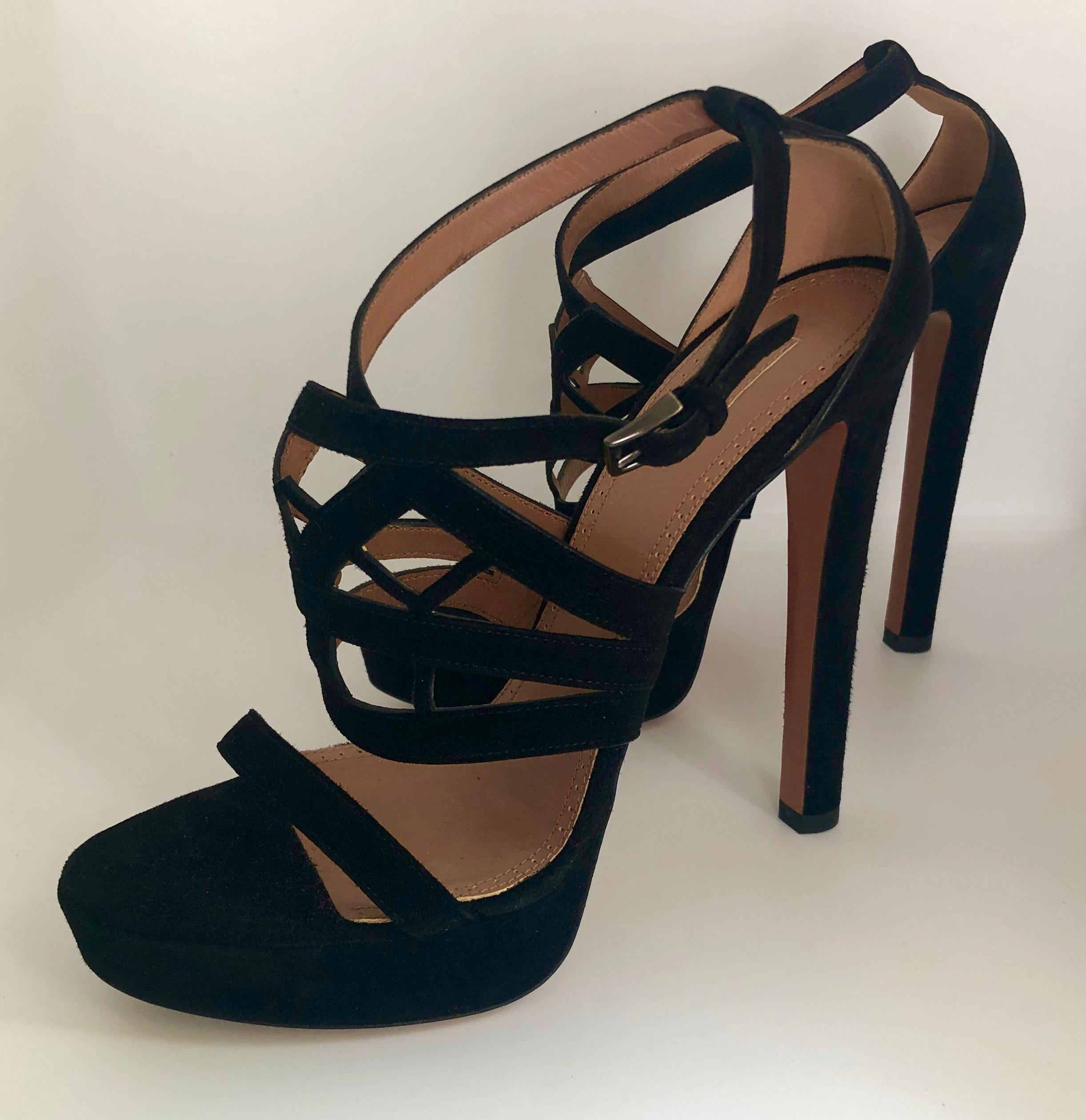 Offered is a pair of Azzedine Alaia, size 39,  black laser cut lattice design strap suede leather with sky high stiletto heel platform sandals. 

Make:  Azzedine Alaia
Size:  39 EU; 2