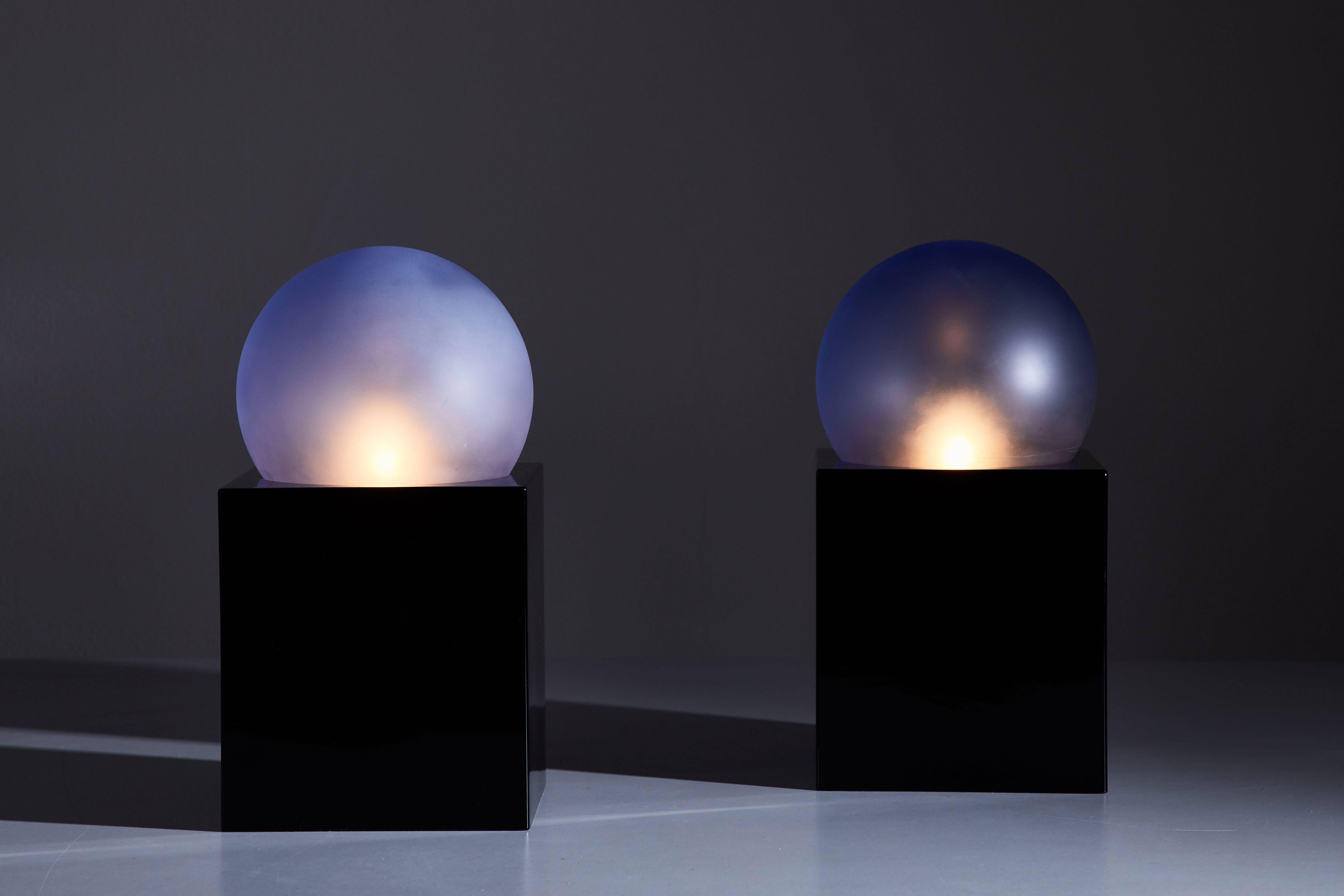 Pair of Alba table lamps by Ettore Sotsass for energy company Enel. Designed in Italy, 2001. Black glass base with blue glass diffusers. Original cords with on/off switch. Each light takes one American candelabra 40w maximum bulb. Manufactures
