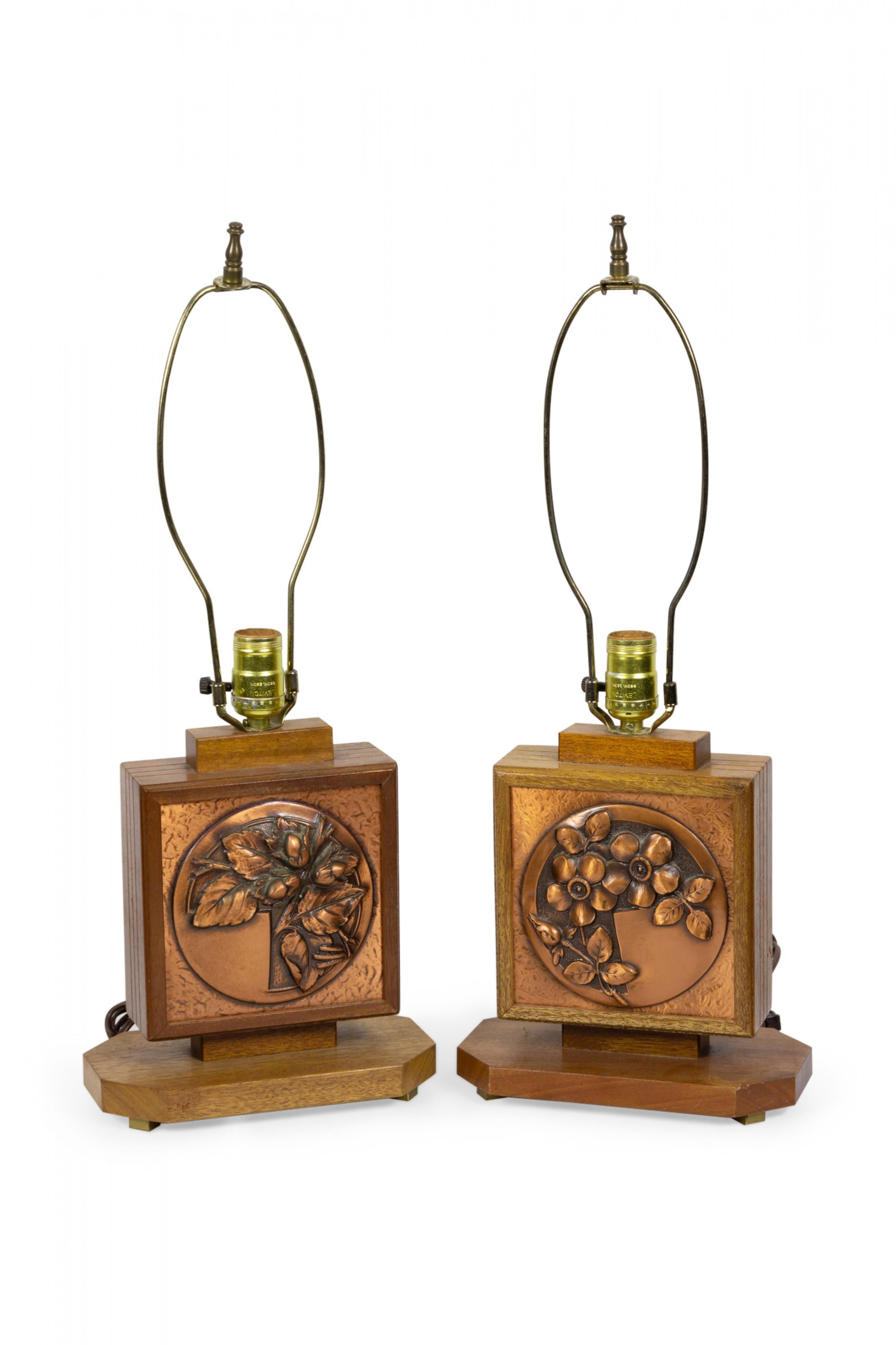 Pair of French Art Deco table lamps with embossed copper plates on either side, one with a floral design, one with an oak leaf and acorn design, mounted in wooden frames having square parchment shades connected with embossed copper. (Albert Gilles).