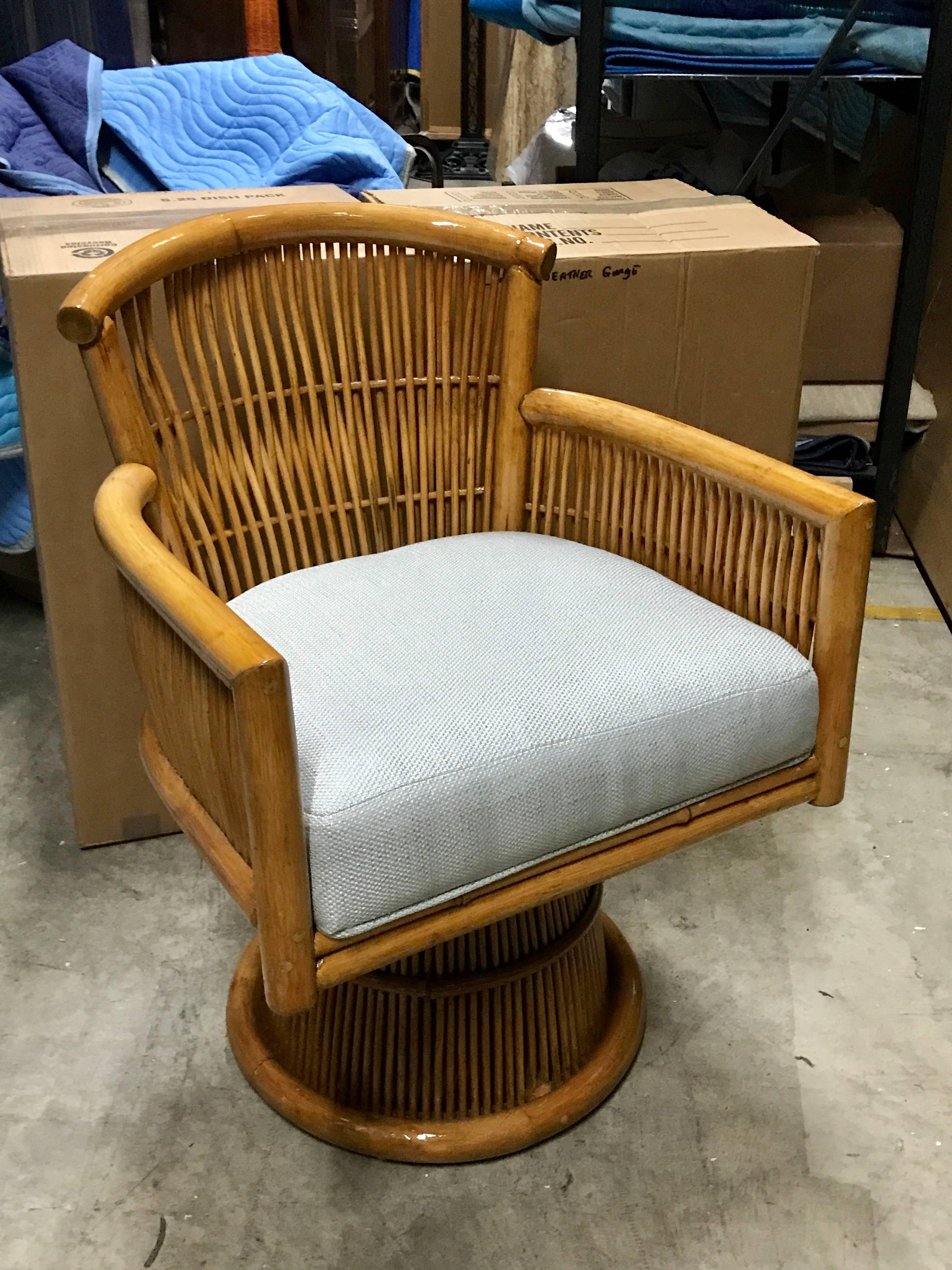 Pair of Franco Albini style rattan and bamboo swivel chairs, each one raised on a 16