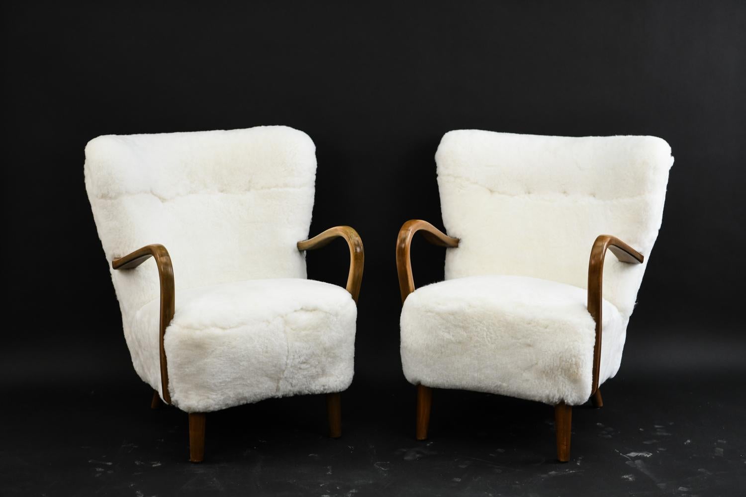 This chair was designed by Danish furniture designer Alfred Christensen in the 1940s and manufactured by Slagelse Møbelfabrik. Beautiful wingback design with lambswool upholstery. Wonderfully curved arms.