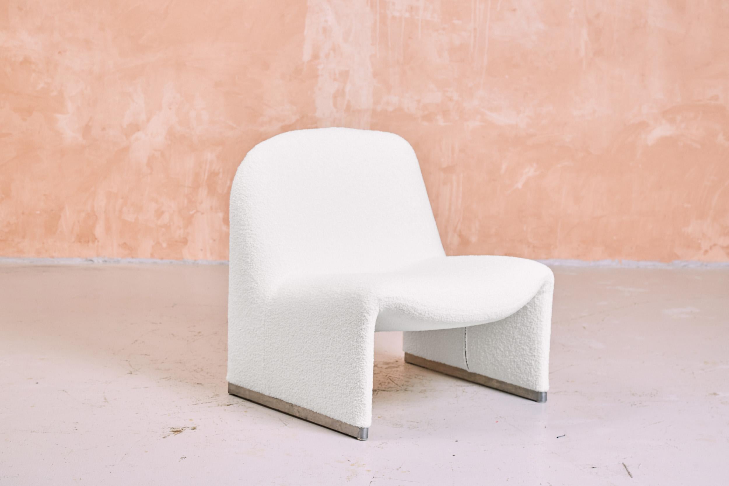 A pair of Alky chairs by Giancarlo Piretti, freshly re-upholstered in white bouclé fabric. The alky chair is an Italian mid century design classic, produced by Castelli in the 1970s. Piretti intended the Alky chair to appear as one seamless form and