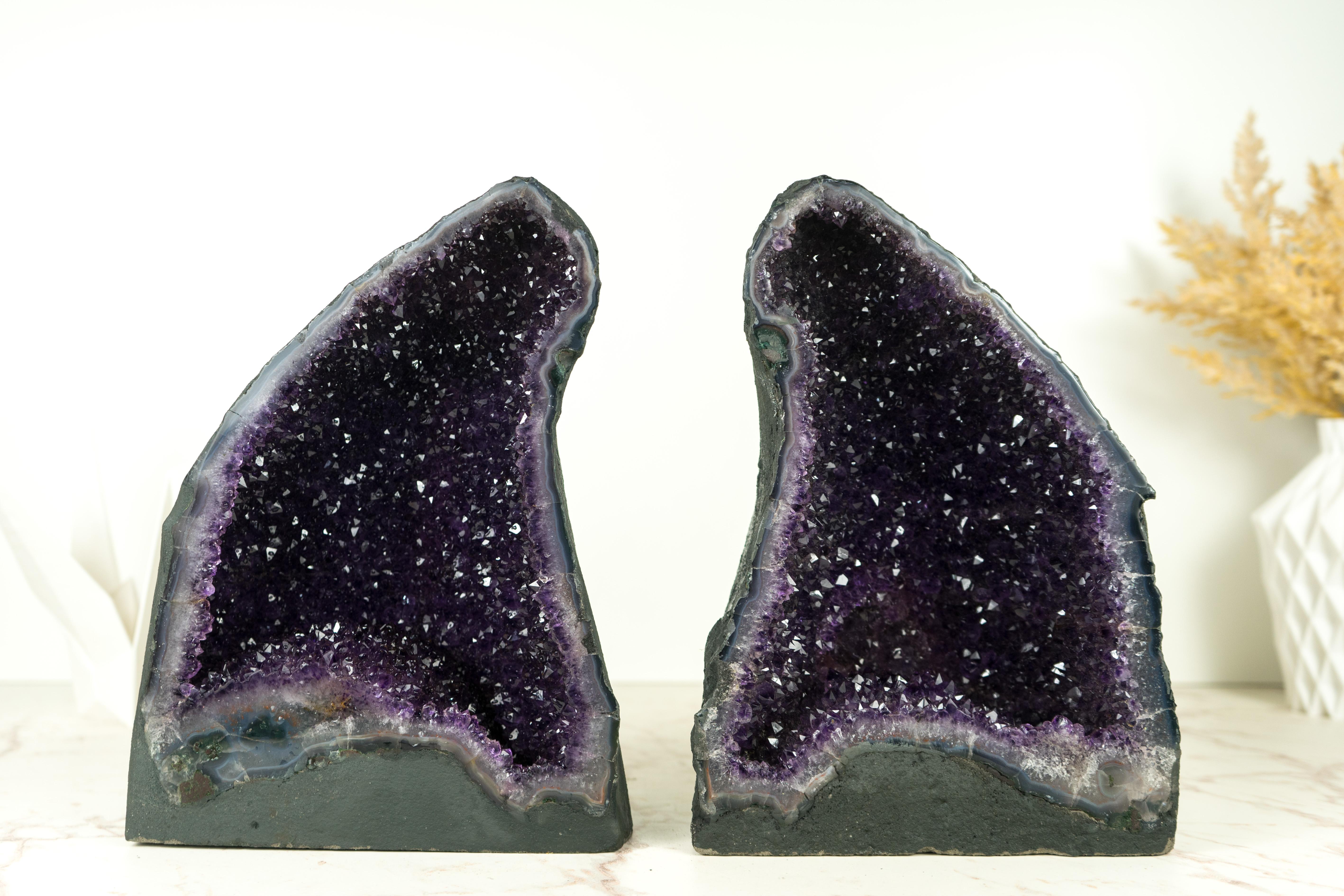An exquisite pair of Amethyst Geode Caves, these specimens stand as a testament to nature's artistry. Formed over millions of years, this geode boasts unique and rare characteristics, including the sparkling galaxy Amethyst, a deep natural purple