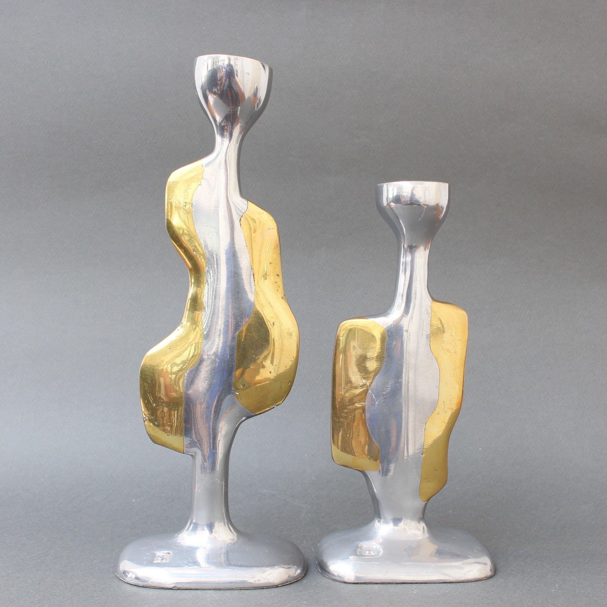 Pair of brutalist aluminium and brass candlesticks by David Marshall (circa 1970s). Very unique pair of candlesticks which are both weighty and tactile, curvy and sensuous. The maker's mark is impressed on the surface of the base. The underside of