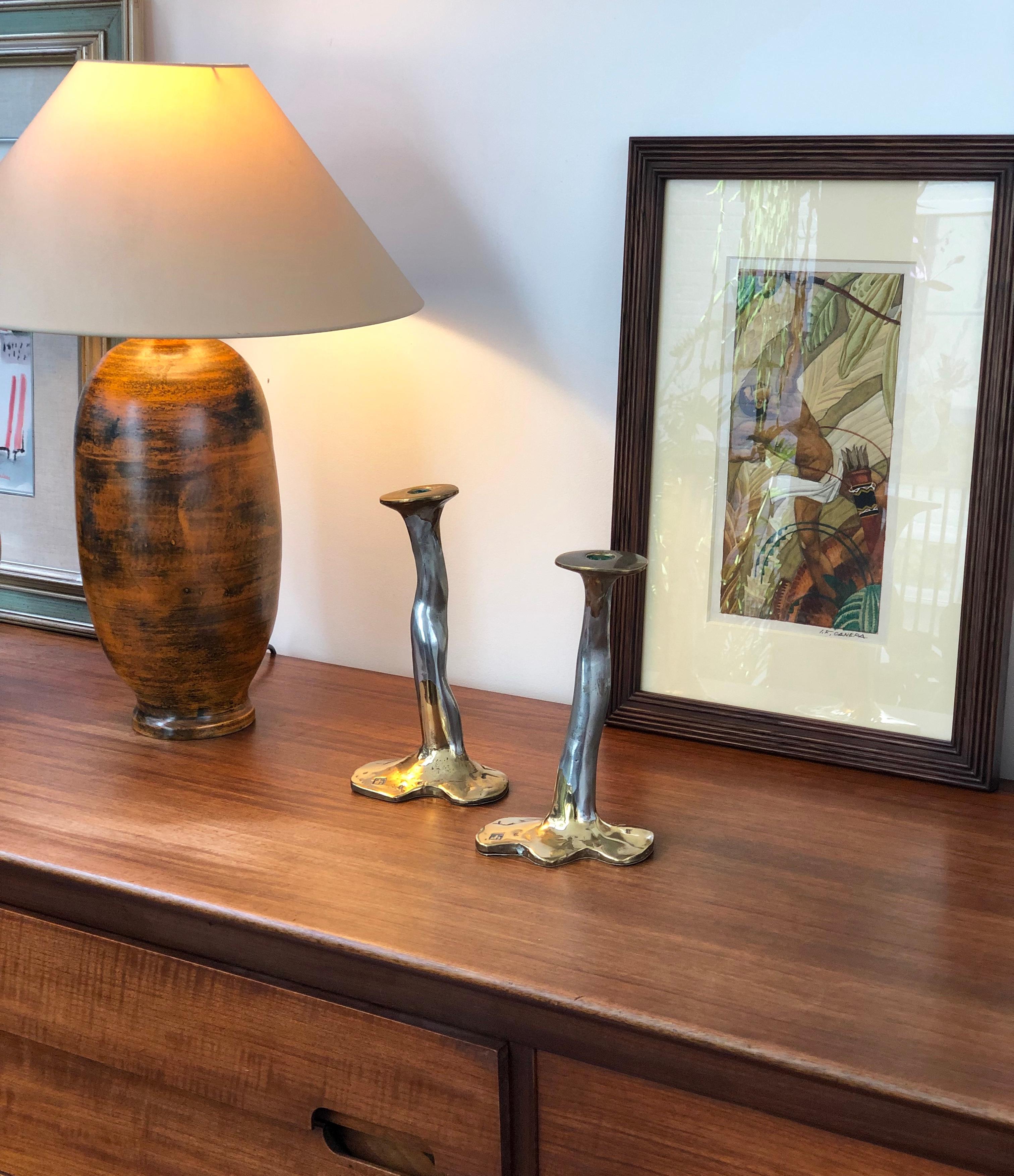 Pair of Brutalist aluminium and brass candlesticks by David Marshall, circa 1970s. Very unique pair of candlesticks which are both weighty and tactile, curvy and sensuous. The maker's mark is impressed on the surface of the base. The underside of