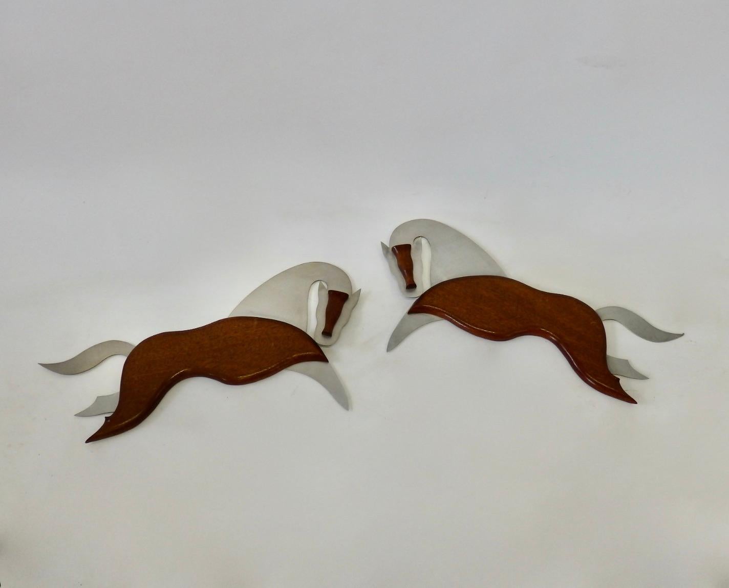 Pair of aluminum and mahogany equestrian wall sculptures.
Measurements in details are for a single sculpture.