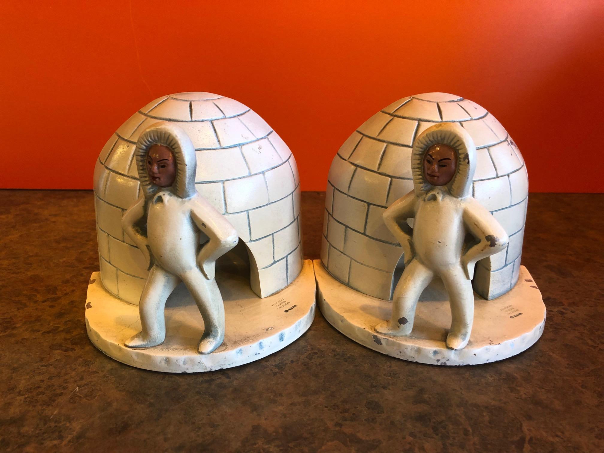 Wonderful pair of aluminum bookends of an Eskimo outside an igloo by Kentucky Tavern Creation, circa 1940s. The bookends are in overall very good vintage condition with some small dents and paint chips (please see pictures). My understanding is that