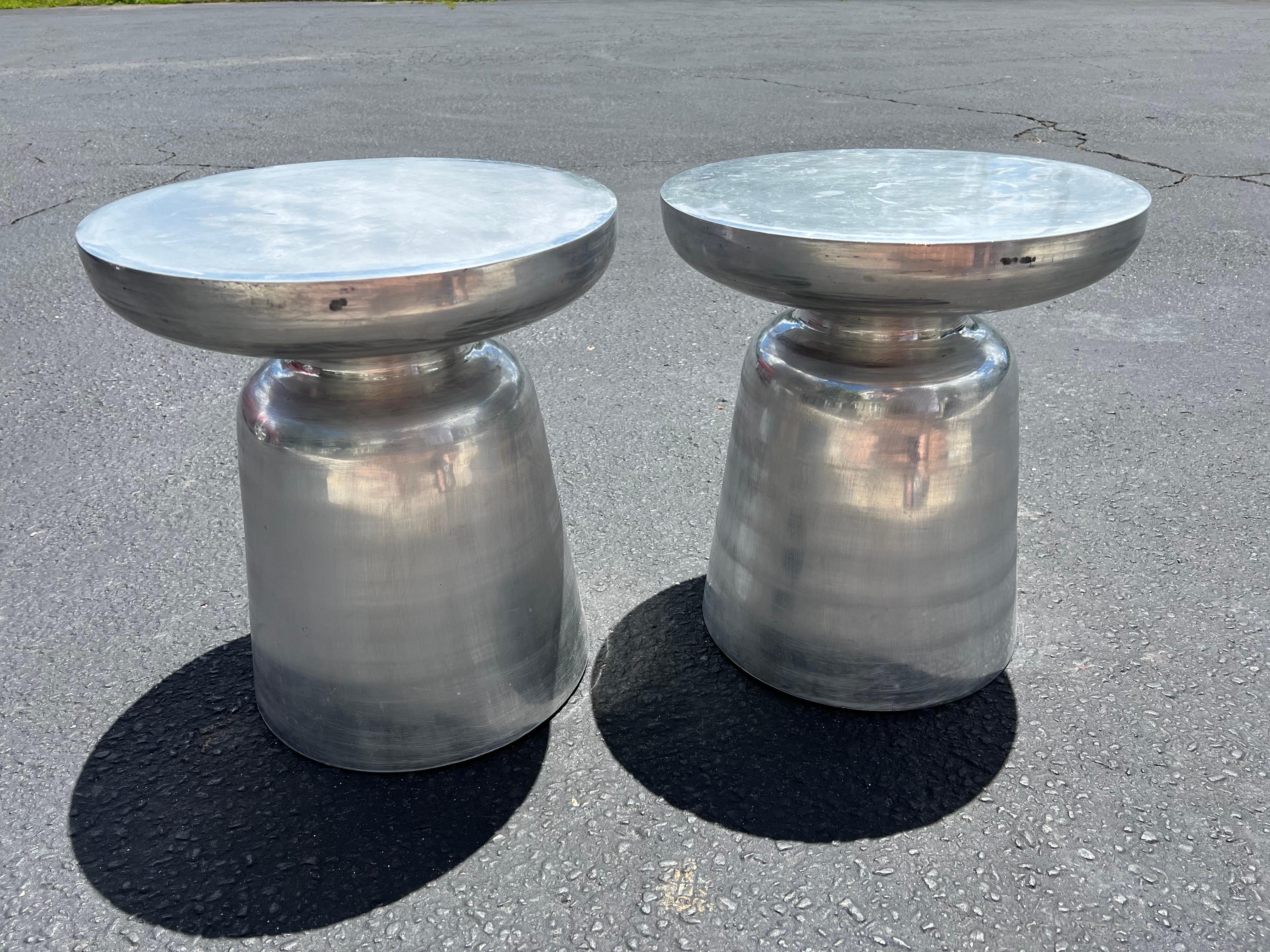 Pair of aluminum Martini tables. Weathered, industrial look. Perfect for that bachelor pad or small living space. Use as a table for martinis or as a plantstand. Or use outdoors by the pool.
     