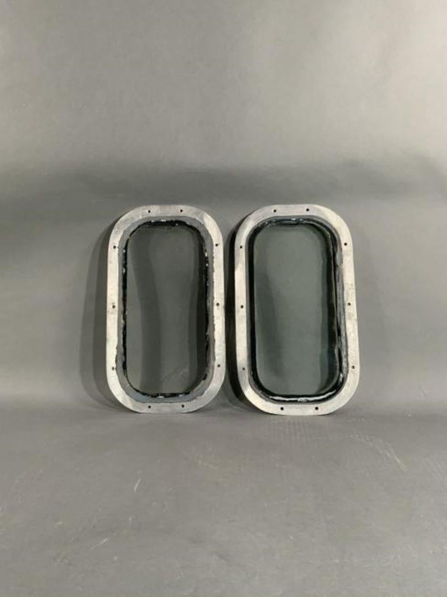 Pair of aluminum ships portholes. Rectangular in shape. Pierced with ten holes each.

Overall Dimensions: Weight is 4 pounds each. 16