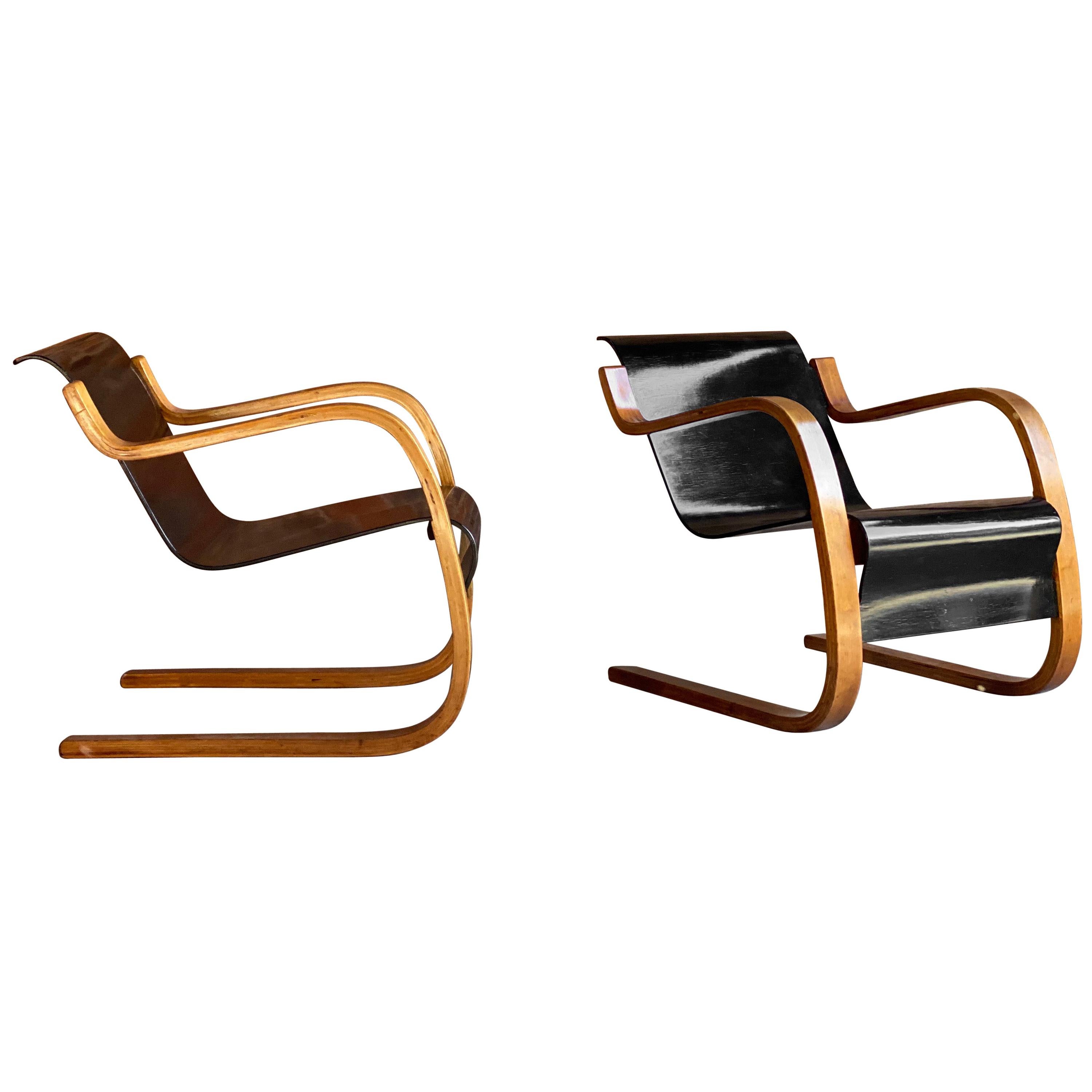 Rare pair of Alvar Aalto Model 31 armchairs for Finmar, Finland, circa 1930s 

Alvar Aalto pair of Model 31 laminated birch and plywood cantilever armchairs circa 1930s, with blackened seat and back. Designed by Alvar Aalto for Finmar. With