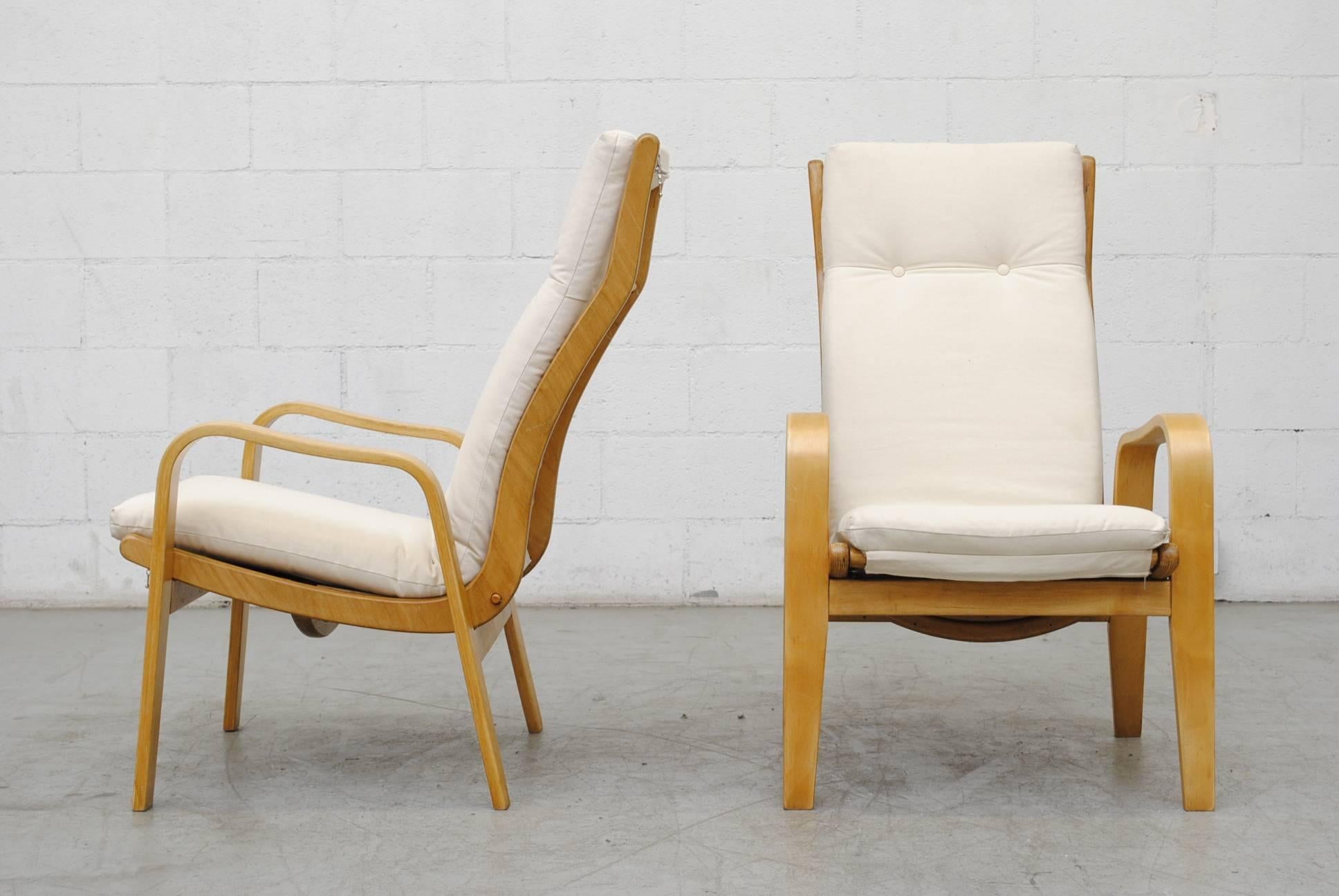 Pair of lounge chairs newly upholstered in natural canvas by Cees Braakman for Pastoe. Bent natural plywood frame in the style of Alvar Aalto. In good original condition with some signs of wear consistent with age and use.