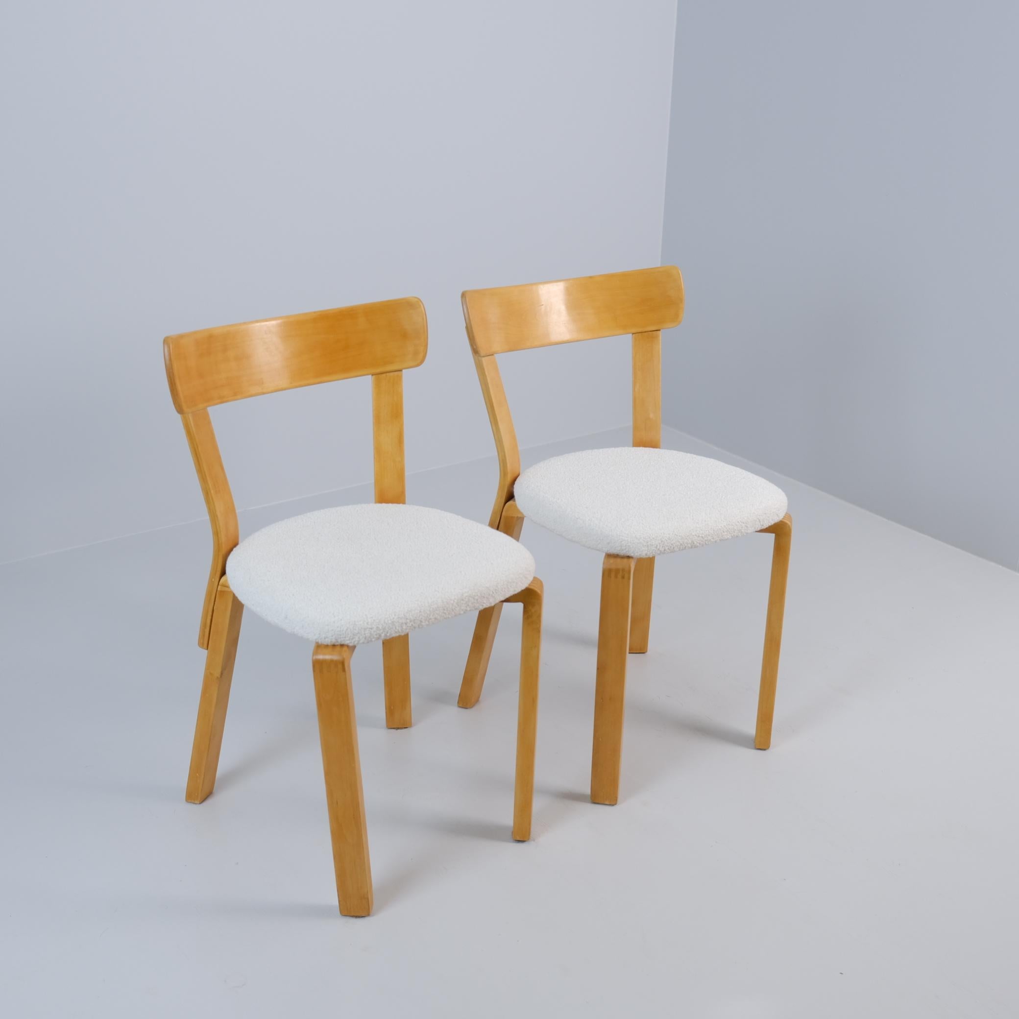 A rare pair of Alvar Aalto model 69 chairs, manufactured during the 2nd World War years in Finland in the 1940s. The iconic L-leg is different in these pieces compared to the normal. As a result of the war, Finland had a shortage of resources