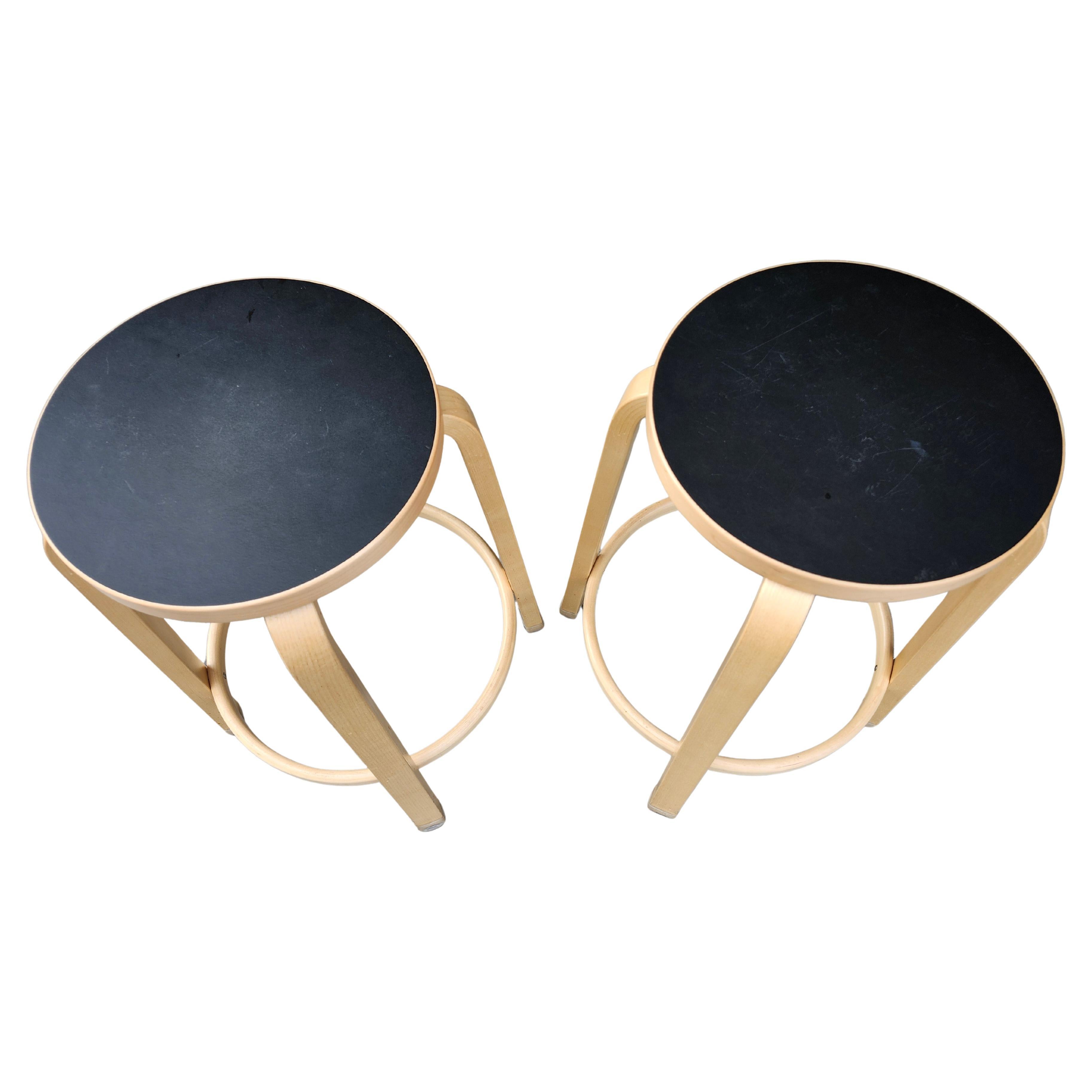 Great pair of Alvar Aalto counter height stools made by Artek, 2016. Signed and dated. Solid birch with black seats pads.
In excellent condition with minimal wear from age and use.  Priced and sold as a pair.  Seat diameter is 13.5