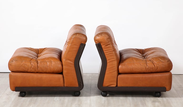 A pair of 'Amanta' cognac brown leather and fiberglass lounge chairs, originally designed in Italy by Mario Bellini for C&B Italia in 1966. The design was extremely popular and in great demand, with a waitlist for eager purchasers. The 'Amanta' was