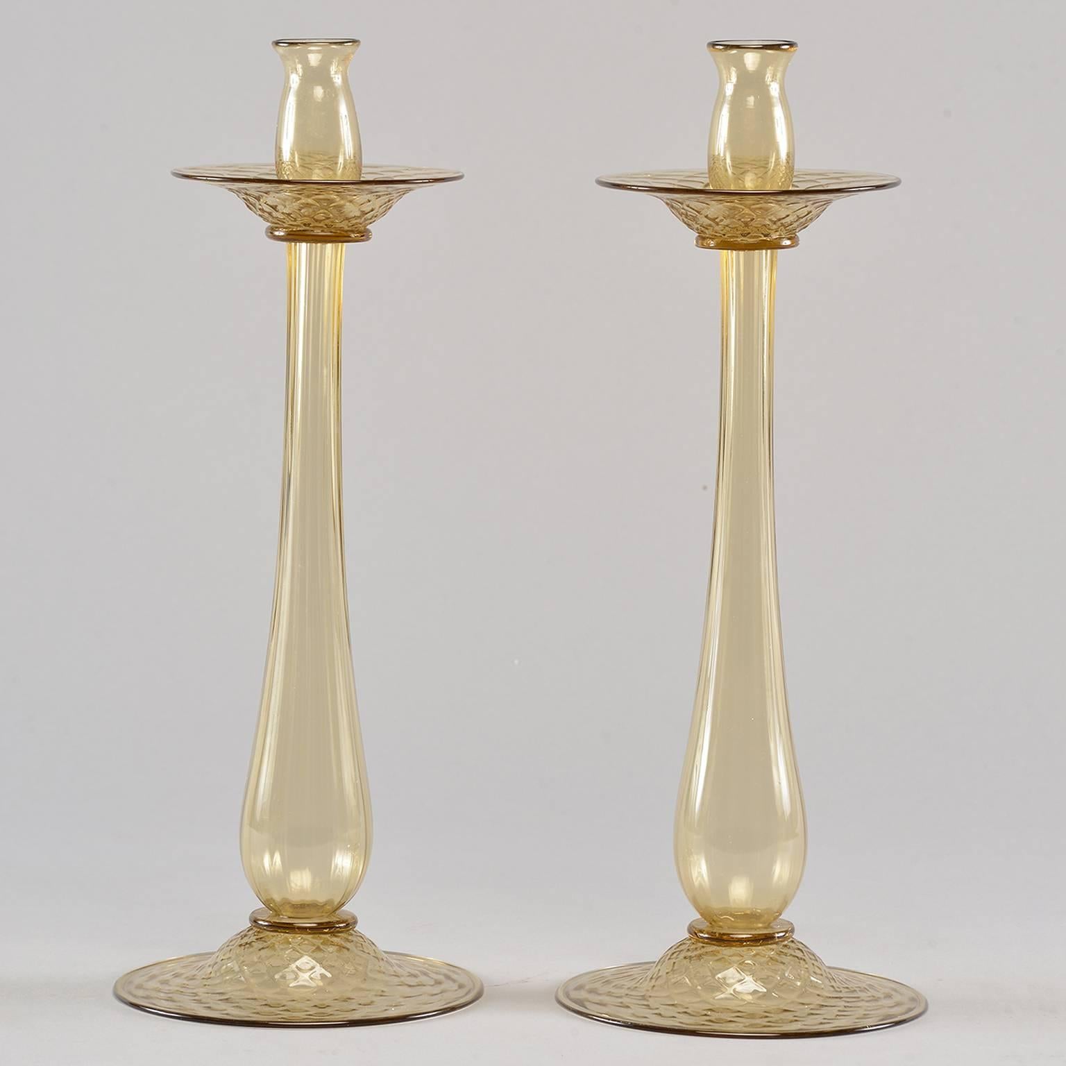 Pair of circa 1930s pale amber handblown Murano glass candlesticks attributed to Barovier and Toso. Bases and bobeches have a subtle surface textured diamond pattern. Unmarked by maker, but obtained in Italy from a reliable dealer of vintage