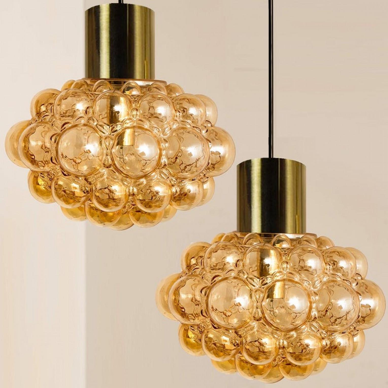 A beautiful pair of bubble glass pendant light designed by Helena Tynell for Glashütte Limburg. A design Classic, the hand blown glass gives a wonderful warm glow.

The dimensions: Height 80 cm from ceiling, the diameter 30 cm. Height of only the