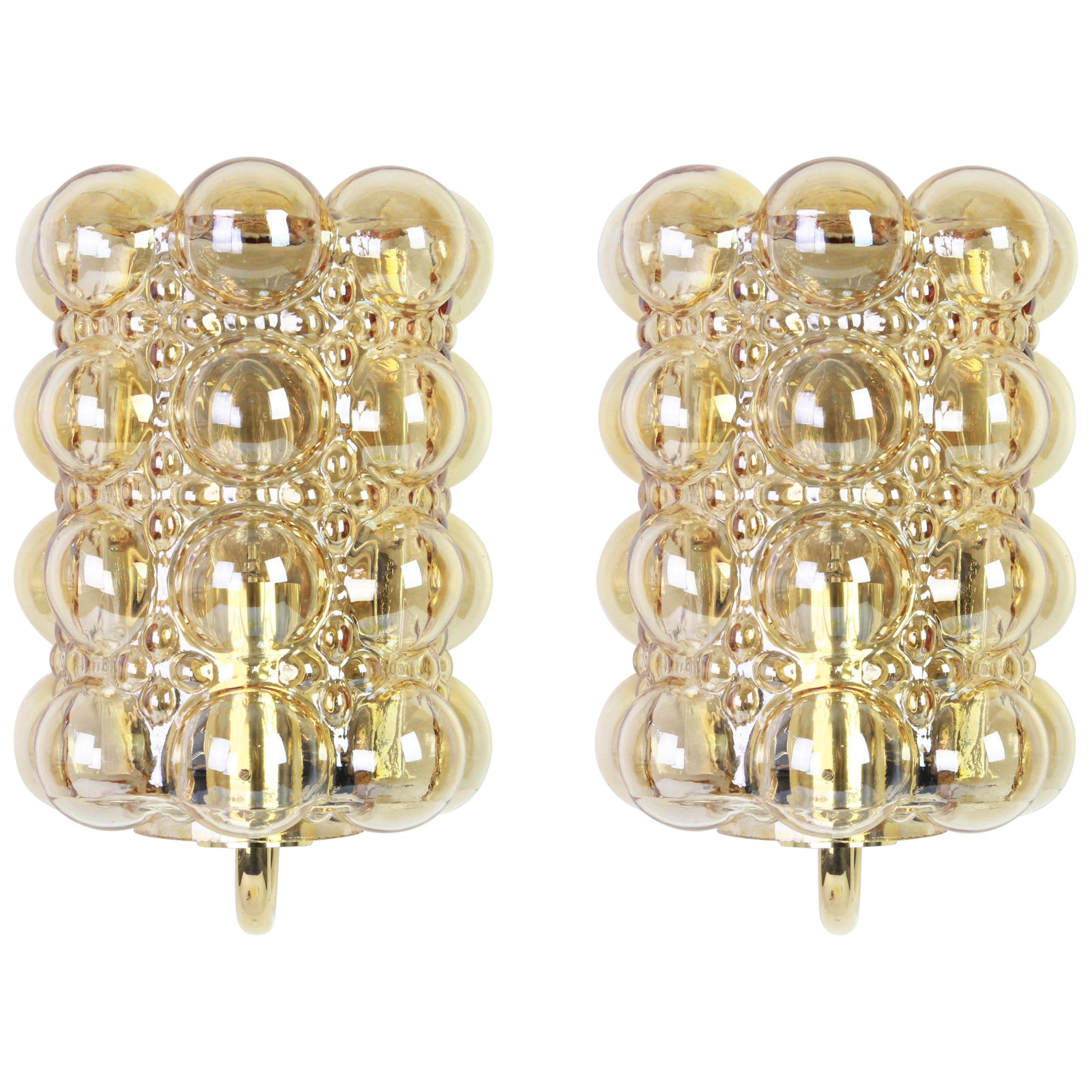Wonderful pair of golden wall lights, from Limburg Glashütte, Germany, circa 1960-1970. Smoked bubble glasses on a golden brass base.

For each sconce:

Heavy quality and in very good condition. Cleaned, well-wired and ready to use. The fixture