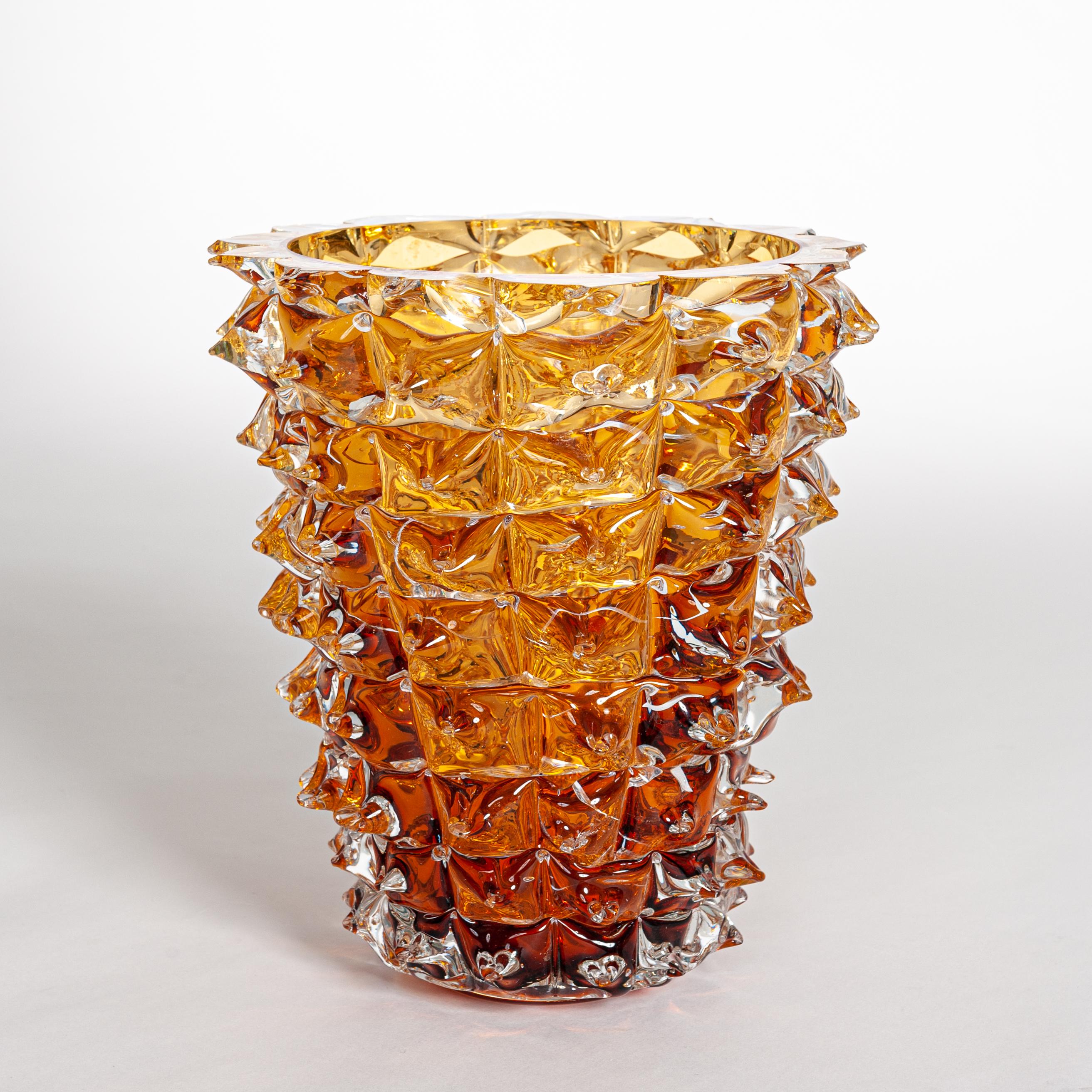 A spectacular pair of Venetian vases, imposing size in clear and amber blown Murano glass,
hand decorated with the technique rostrato: spikes of glass individually pulled in relief.
Thick walled casing glass produces a lot of iridescent