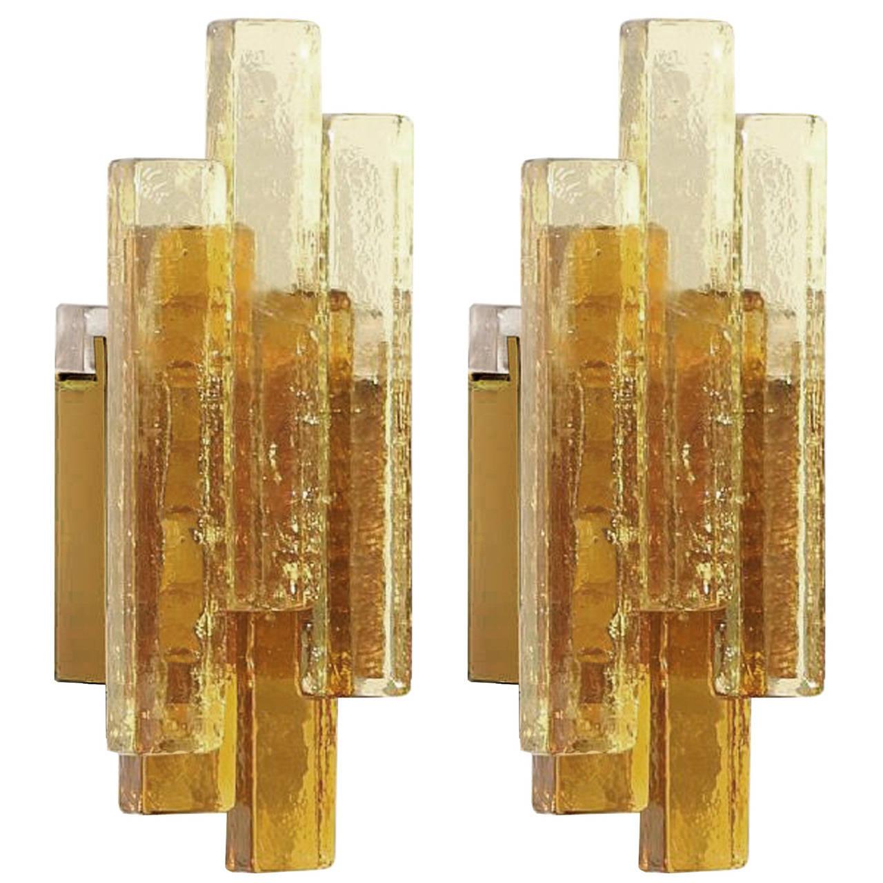 A pair of golden and amber colored glass sconces with brass wall mountings and hardware by Svend Aage Holm Sorensen for Hassel Teudt.

Danish, Circa 1960's

Two (2) Pairs Are Available