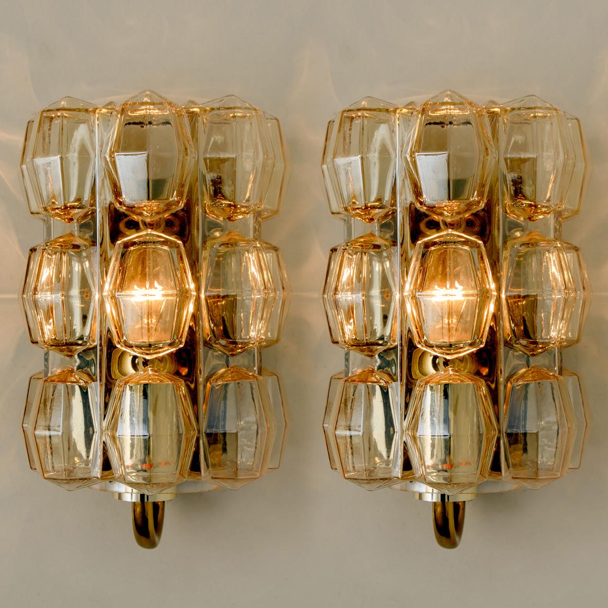 Pair a beautiful amber bubble glass wall lights designed by Helena Tynell for Glashütte Limburg. A design Classic! The wall light has a very strong appearance and spreads a wonderful light. With brass hardware.

Please notice the price is for a