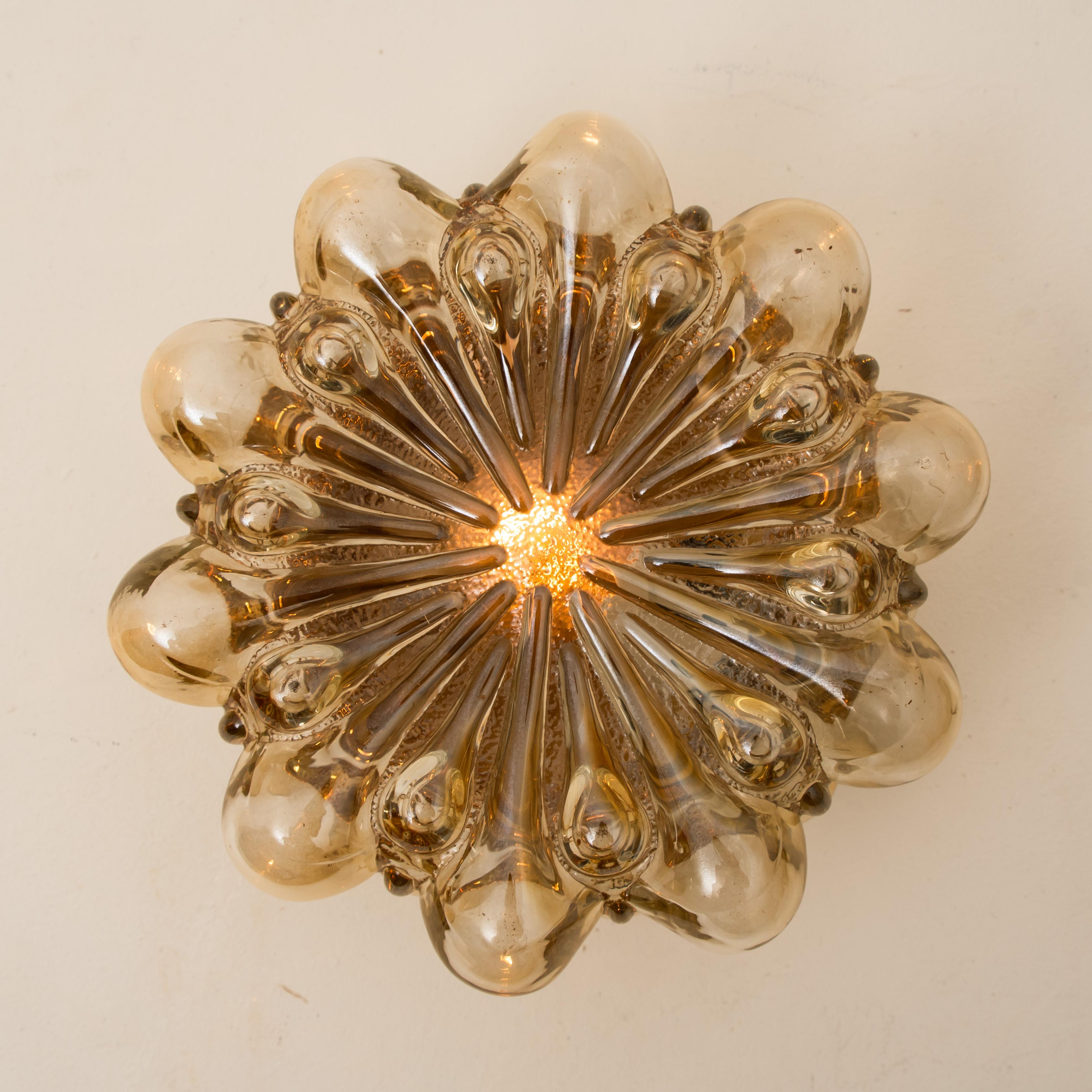 A pair of beautiful bubble glass wall lights designed by Helena Tynell for Glashütte Limburg. A design classic, the amber colored or toned of the hand blown glass gives a wonderful and warm glow. 

Heavy quality and in excellent vintage condition.
