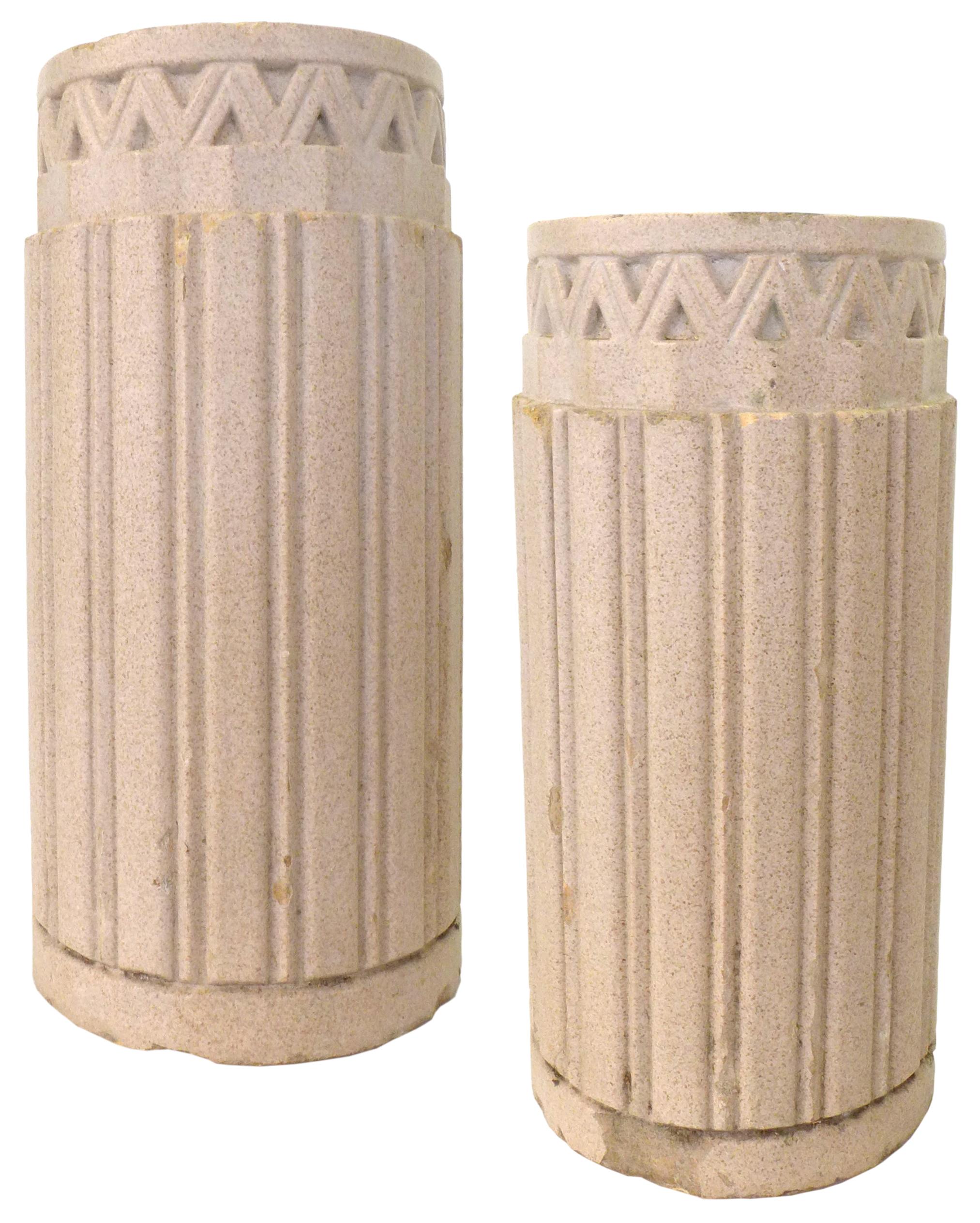 A wonderful pair of architectural planters by Gladding, McBean & Company. Powerful, fluted columnar vessels crowned with geometric ornamentation. Minor wear throughout from years of life outdoors, adding to the pieces' presence and history.