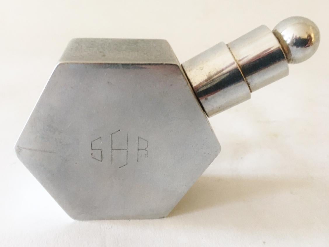 This pair of American Hex-o-Lite Art Deco/Machine age polished aluminum wheel and flint table lighters were manufactured by the Blazon Company of Detroit. One is engraved with the 