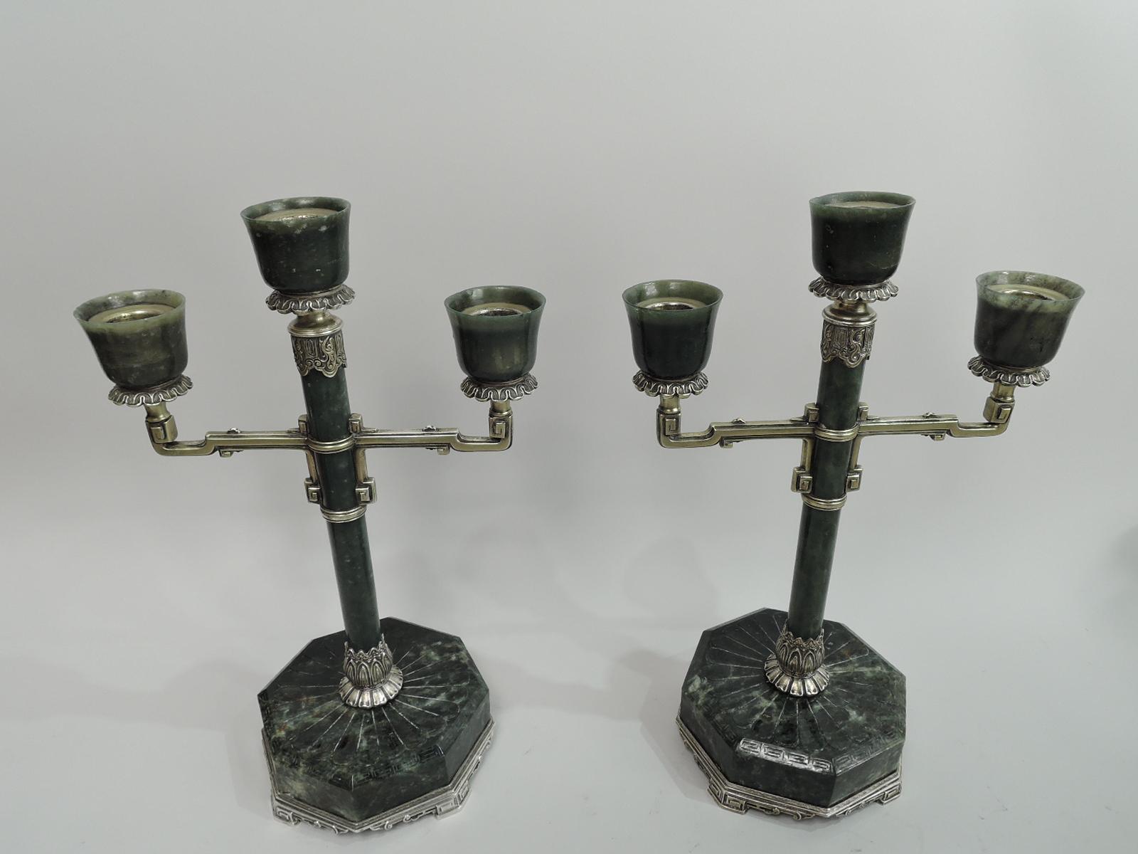 Pair of Art Deco Classical jade and gilt sterling silver candelabra. Made by Lebkuecher in Newark, ca 1920. Each: Cylindrical jade shaft on same octagonal base with carved petal flutes and fretwork. Curvilinear silver gilt arms with block volute