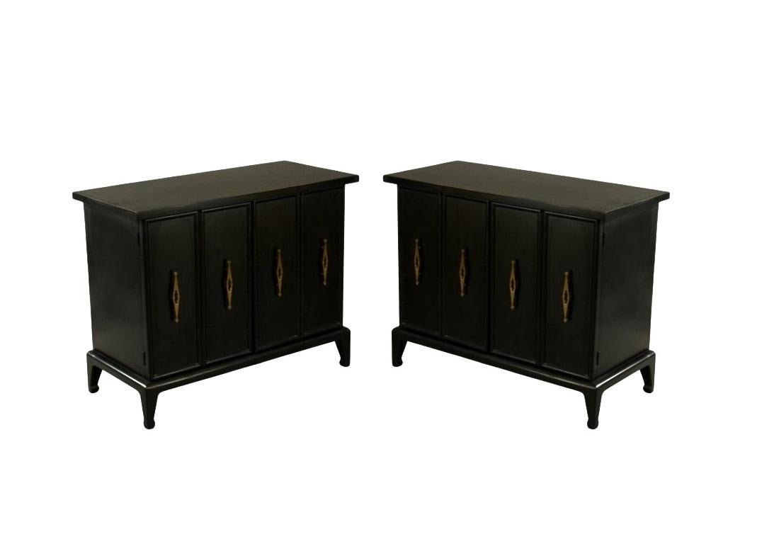 Fine pair of 1960's black lacquered cabinets with a design influenced by the work of the illustrious American designer James Mont. Mont was renowned for assimilating elements of classical, orientalist, and Art Deco design into a modern sensibility -