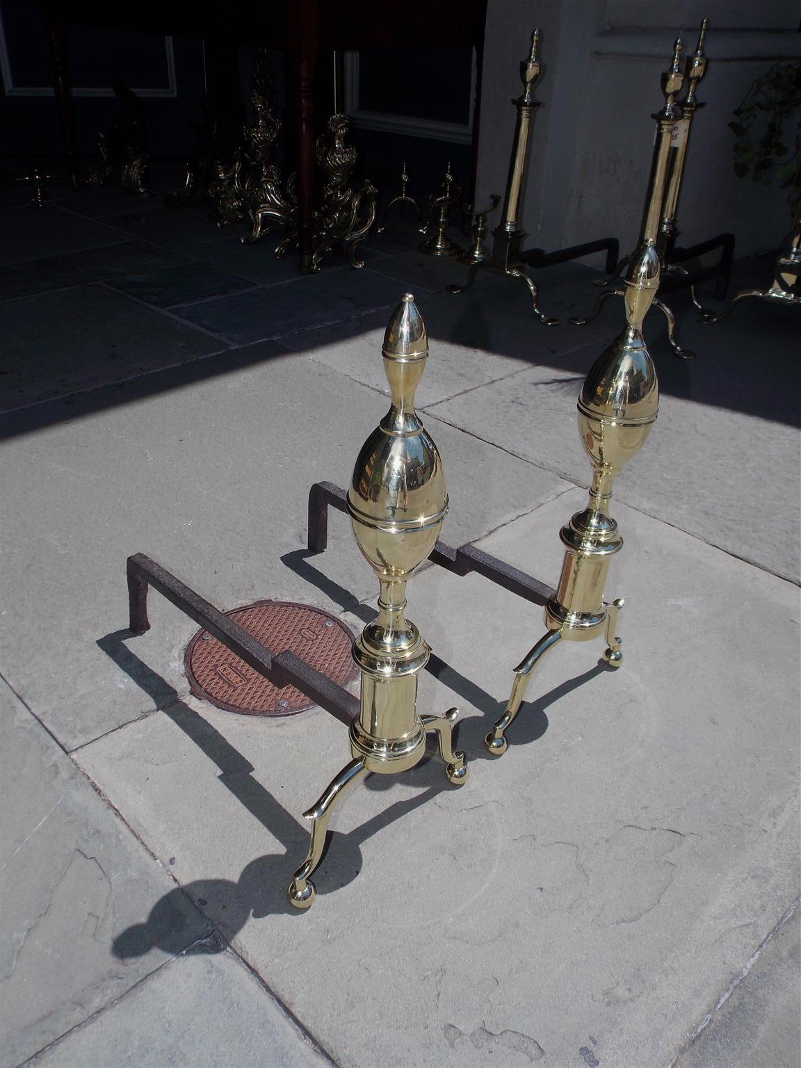 Pair of American brass and wrought iron lemon on lemon andirons with double lines of beading , circular turned round plinths, and terminating on spur legs with ball feet. Early 19th Century, N.Y.
