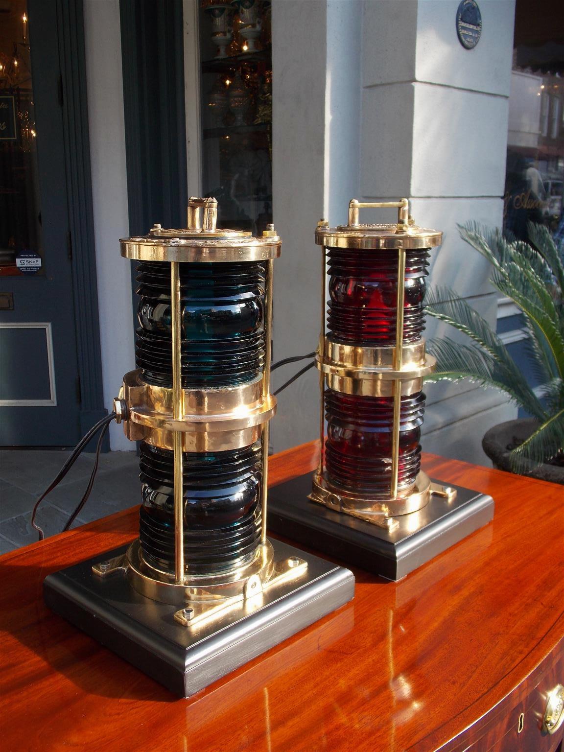 Pair of American brass double stacked maritime beacons with carrying handles, makers stamps, original red and blue 360 degree Fresnel lenses, and mounted on square bases. Manufactured by Lovell-Dressel Company of Arlington, New Jersey.  Beacons have