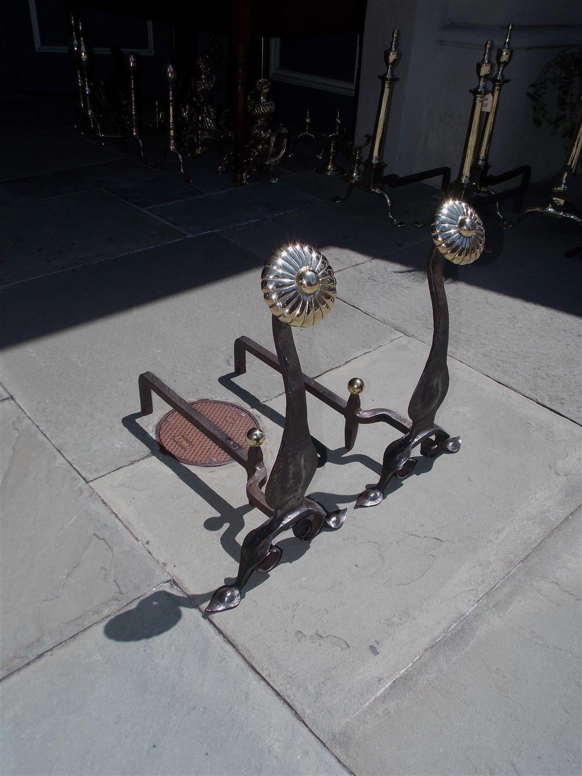 Pair of American brass melon medallion and wrought iron andirons with matching brass ball finial log stops, decorative bulbous squared plinths, and terminating on scrolled stylized spade penny feet, Mid-19th century.
