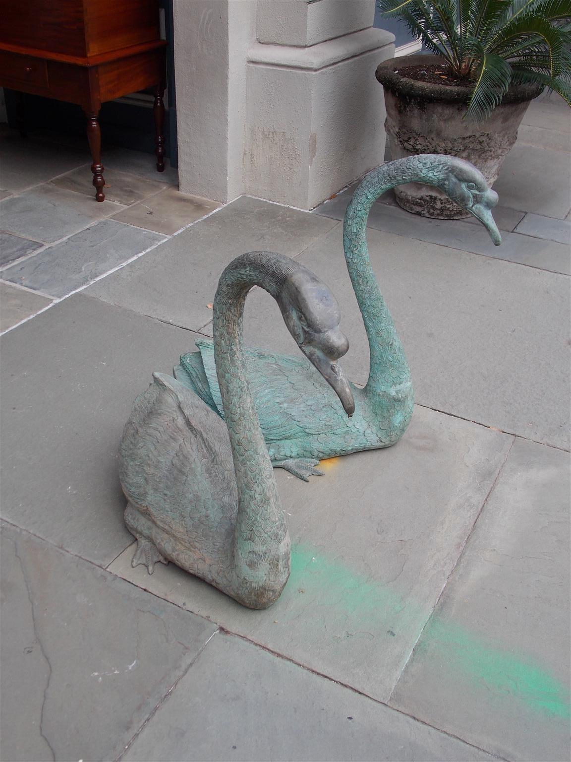 Pair of American bronze swan form garden fountains plumed with copper tubing to have water squirting from each swan's mouth, Mid-19th century.