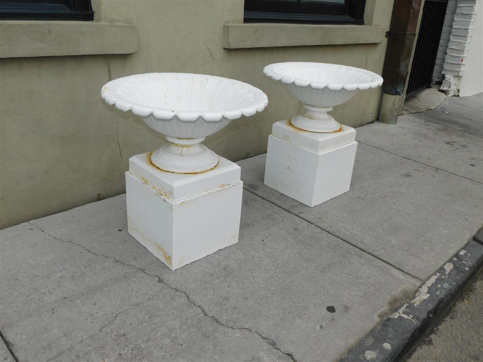 Pair of American Campana form powered coated garden urns on squared plinths, Mid 19th Century
Urns are 13