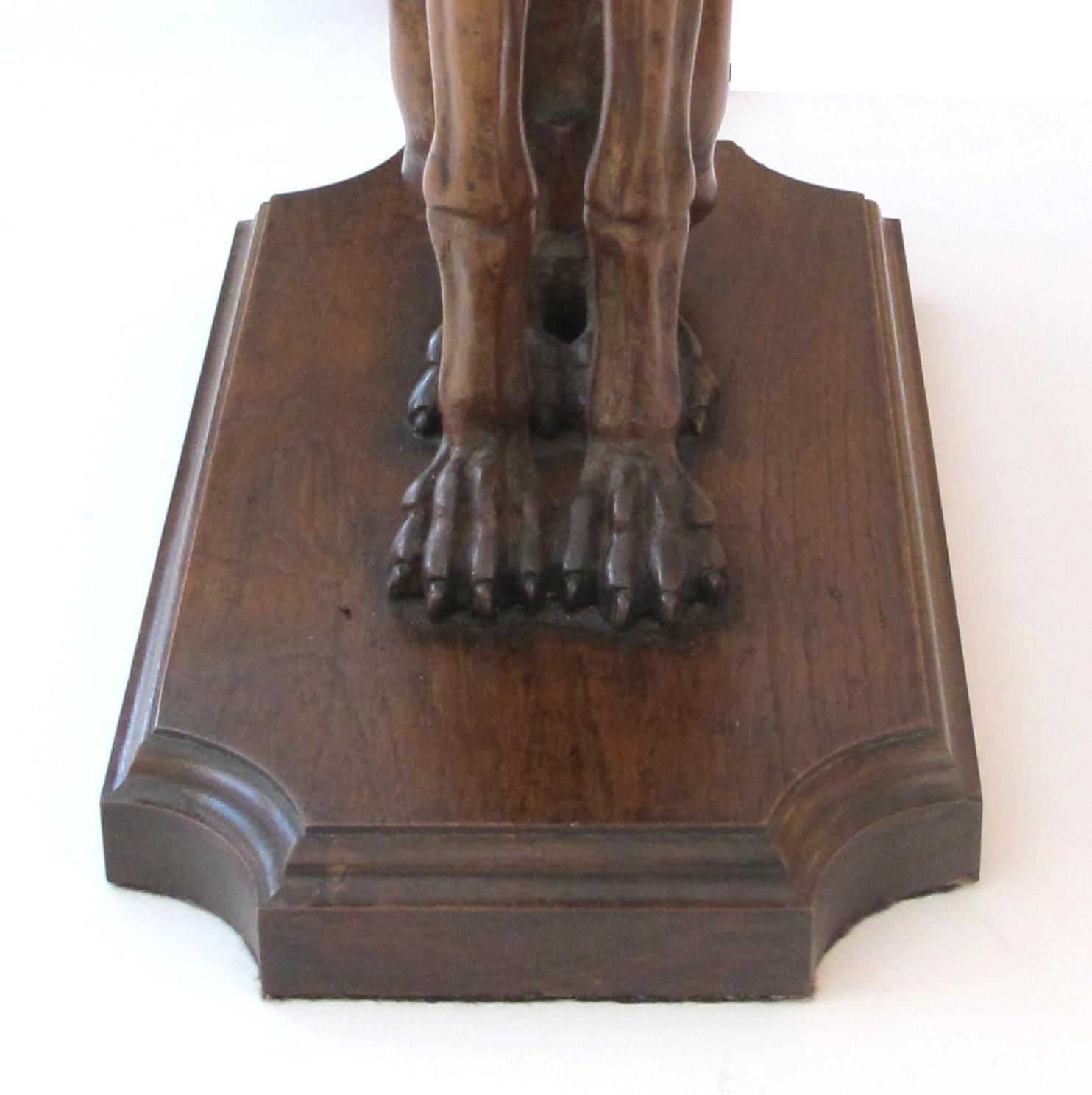 Each hand carved architectural elements of seated greyhounds with direct gaze and muscled bodies, now mounted as lamps.