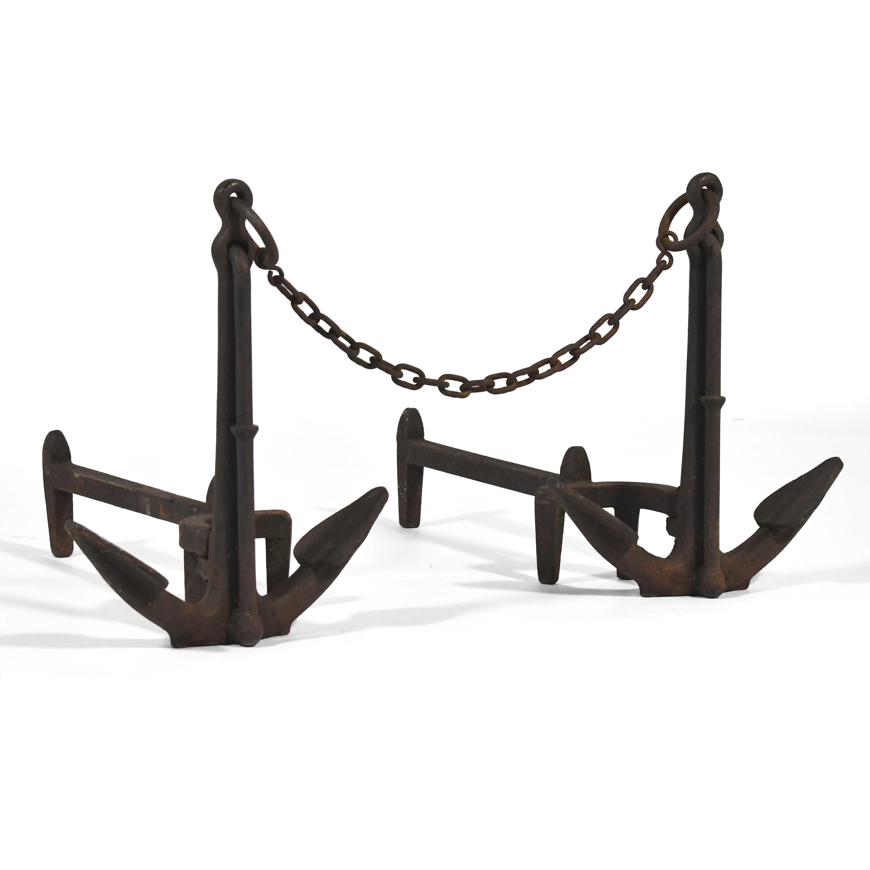 Striking pair of American cast iron anchor andirons connected by anchoring chain. Original log stops and dog legs. The rich patina speaks to their decades of service.

Overall as shown: 16